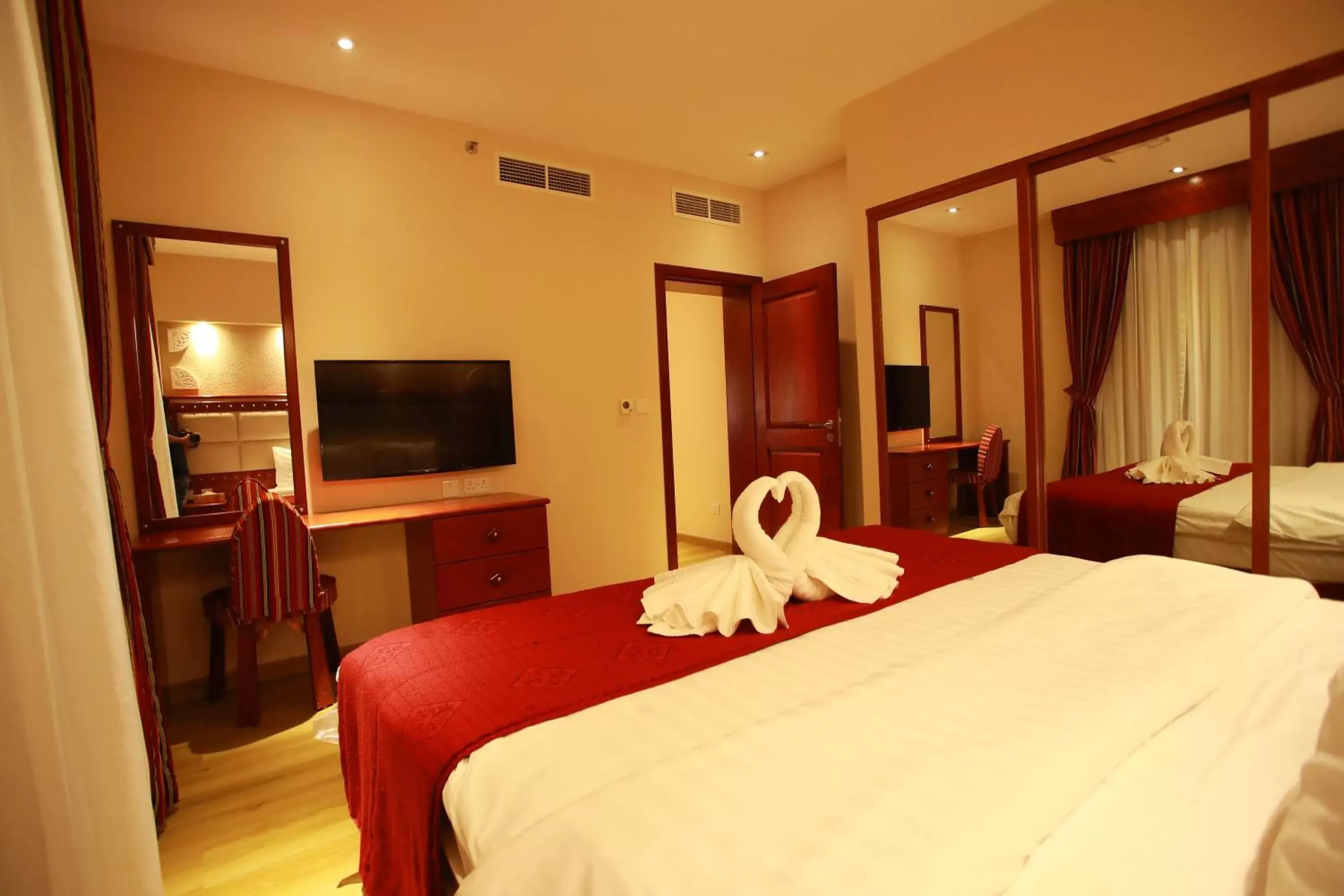 Bedroom, TV/Entertainment Center in Al Liwan Suites Rawdat Al Khail
