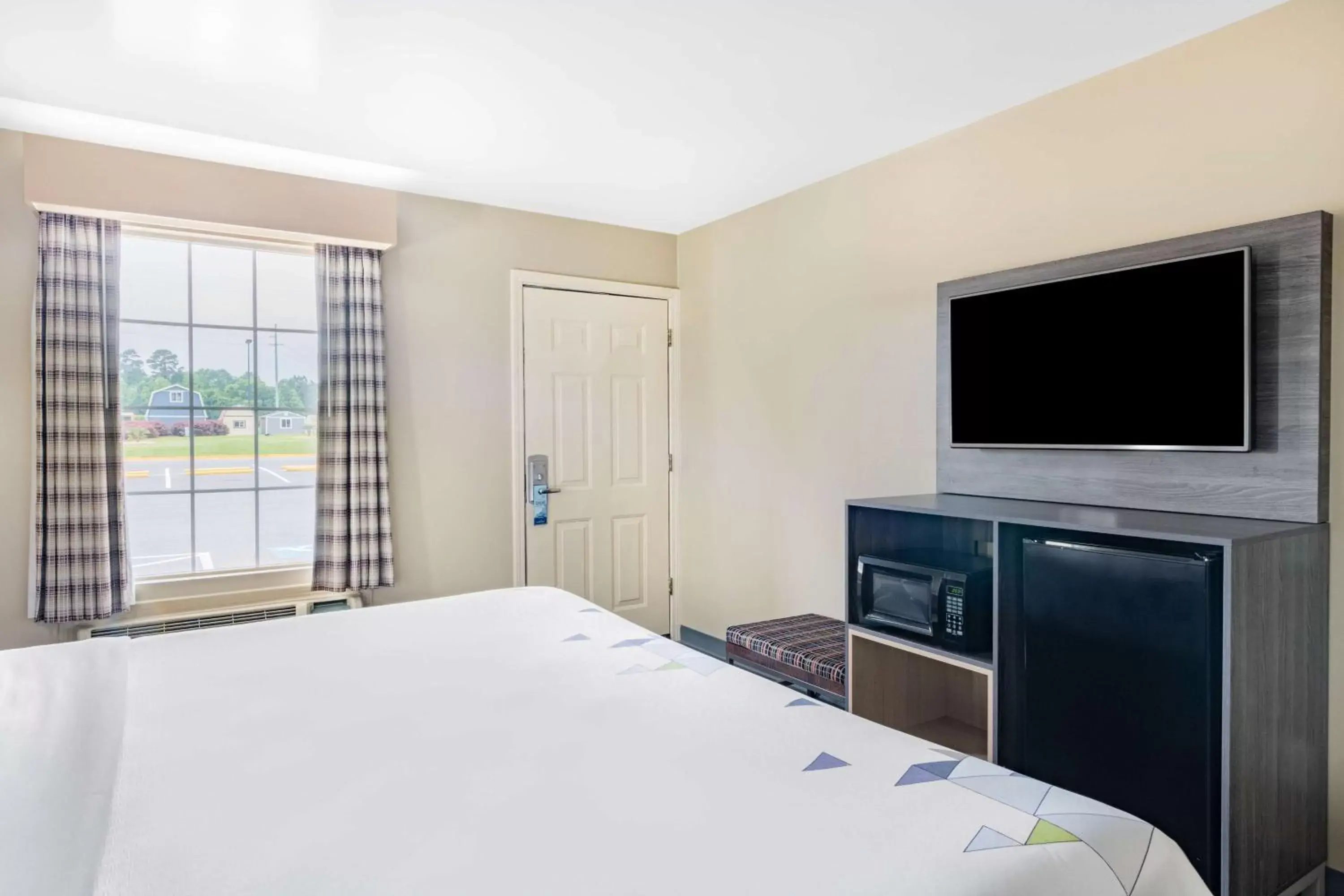 Bed in Baymont by Wyndham Commerce GA Near Tanger Outlets Mall