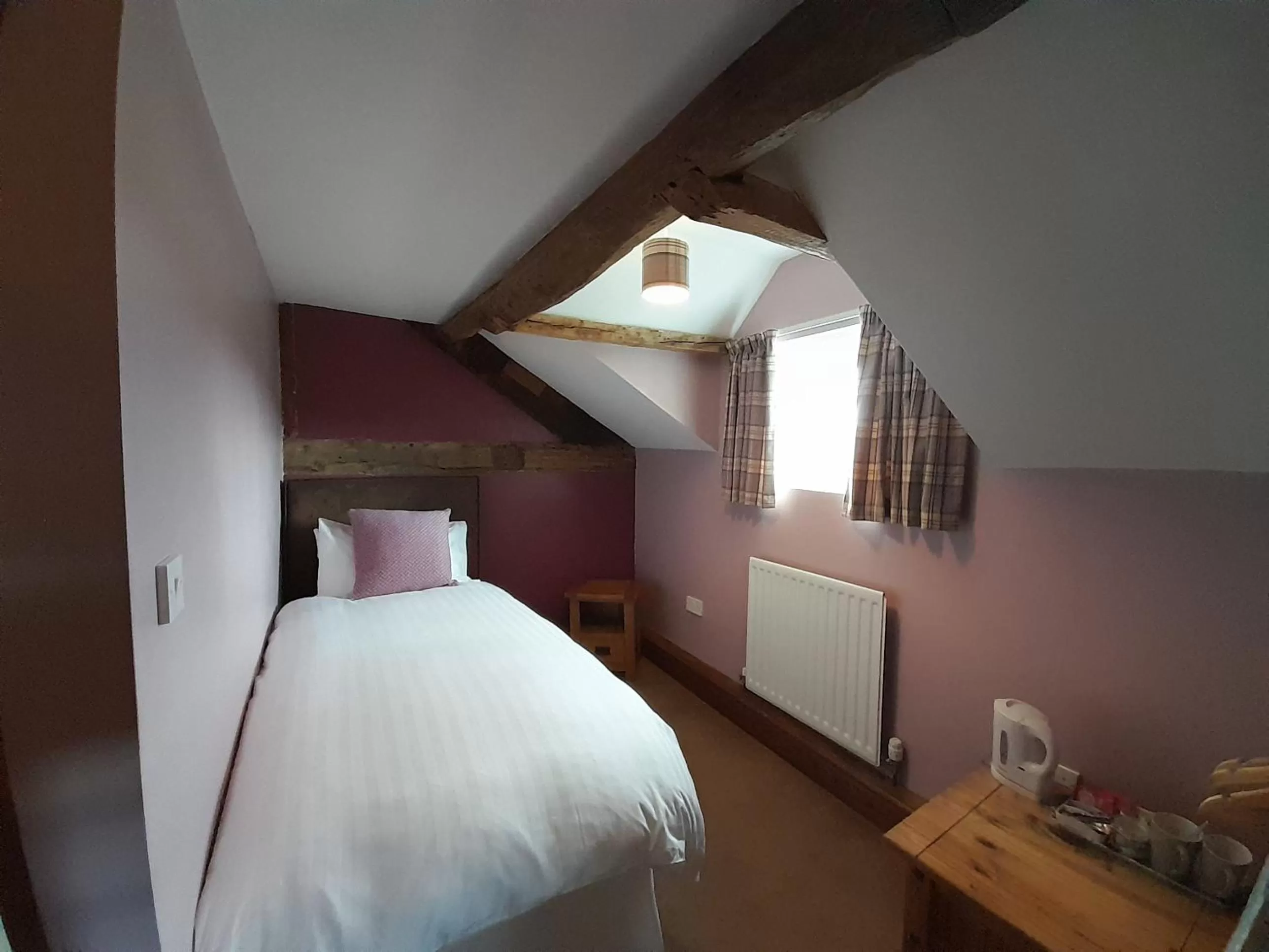 Bed in The Dolfor Inn