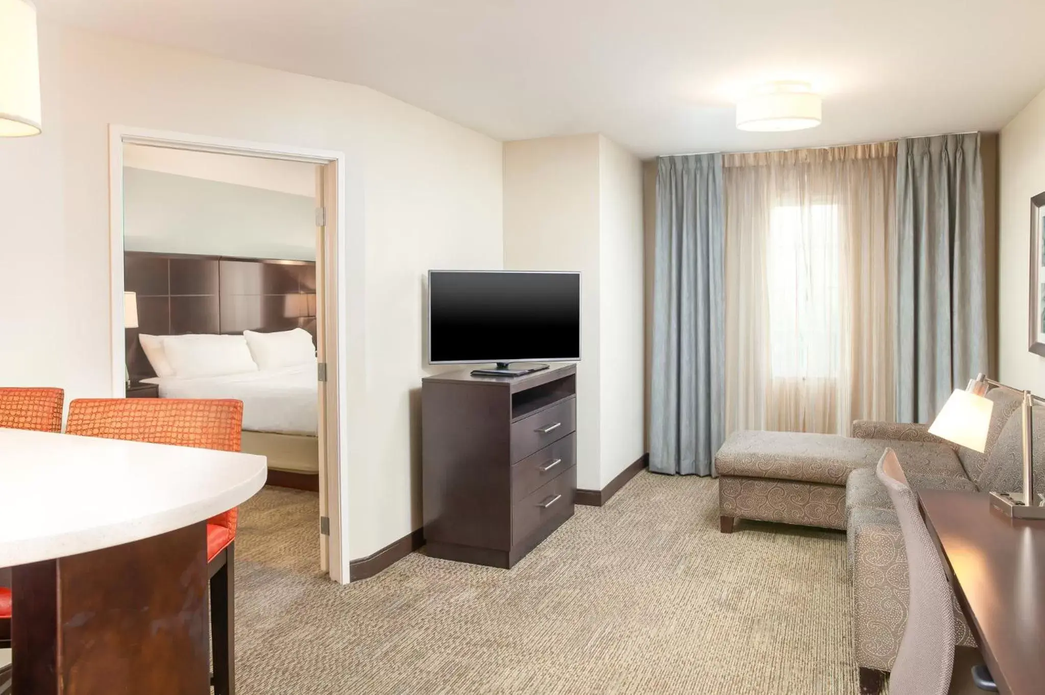 Photo of the whole room, TV/Entertainment Center in Staybridge Suites Chandler, an IHG Hotel