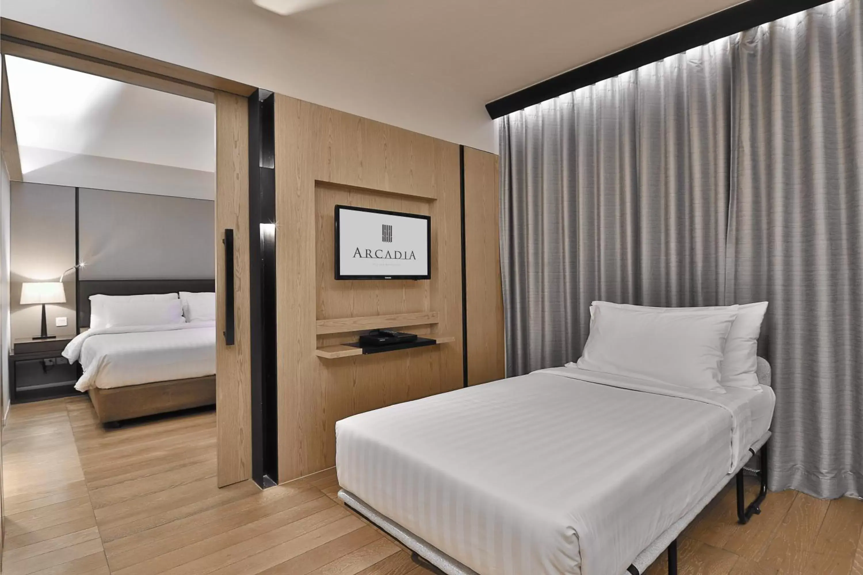 Bed in Arcadia Suites Bangkok