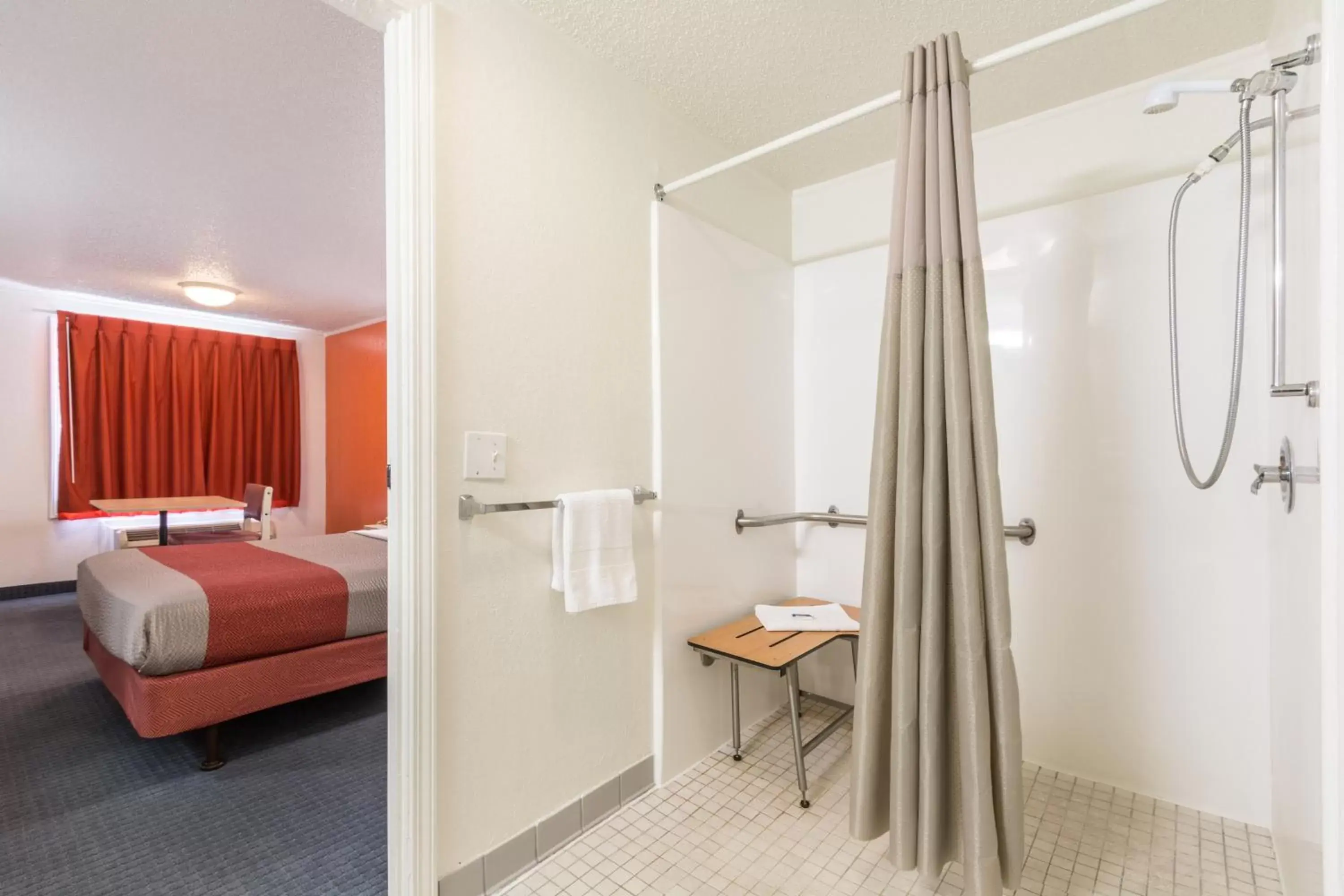 Bathroom, Bed in Travelodge by Wyndham Lansing