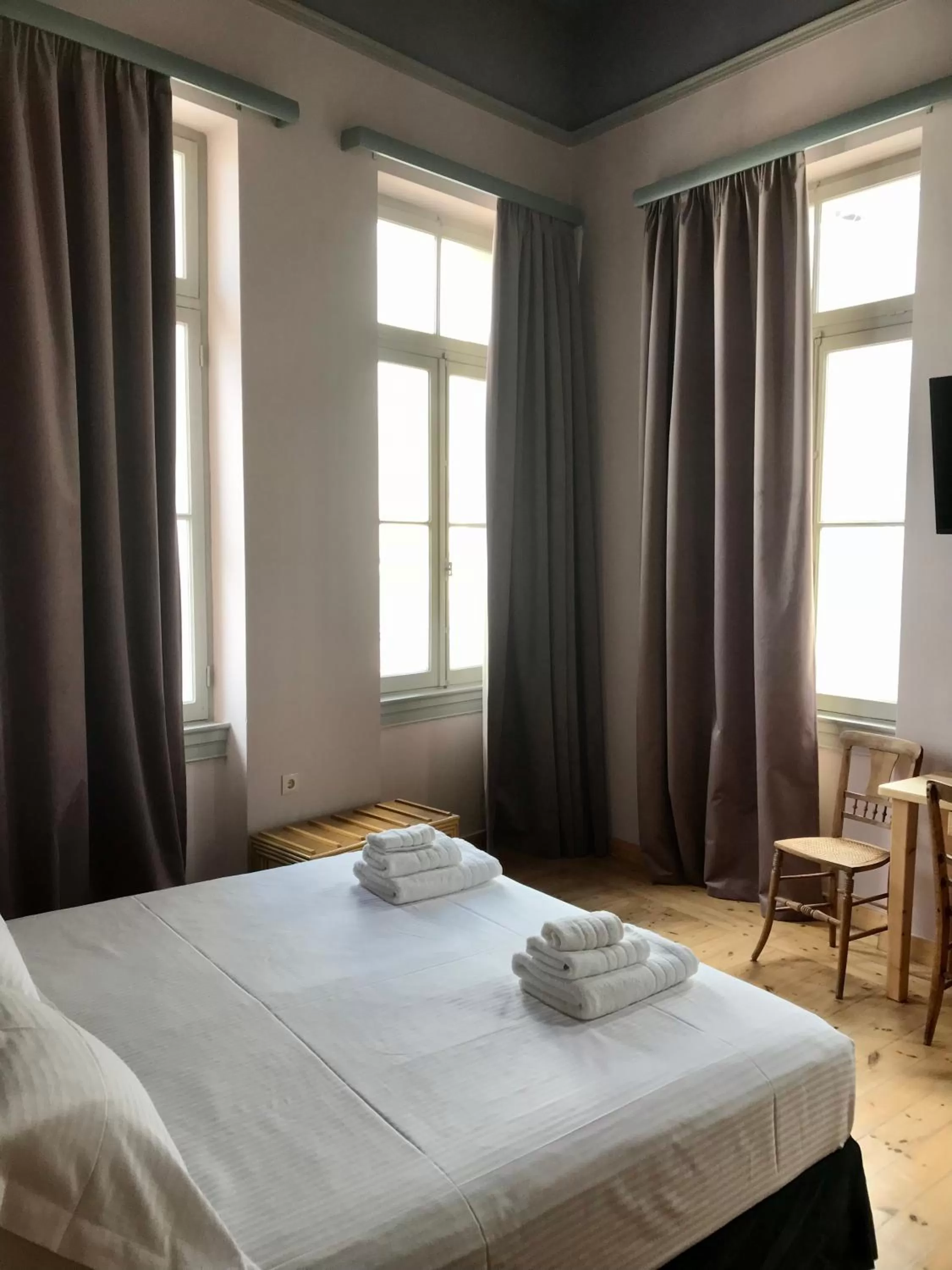 Photo of the whole room, Bed in VASILIKON Hotel 1888 the past is present HISTORICAL PRESERVATION MONUMENT