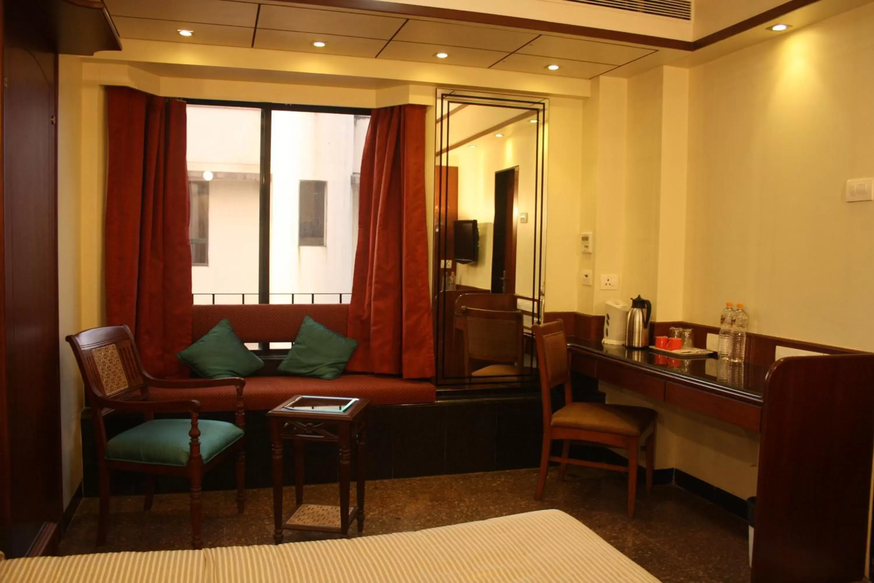 Bed, Seating Area in Hotel Karl Residency