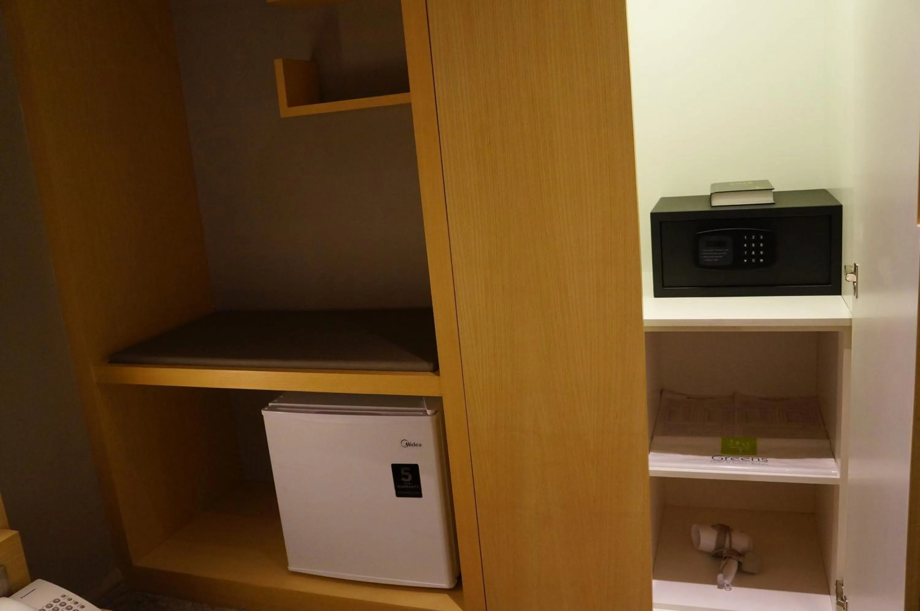 Bedroom in Greens Hotel & Suites