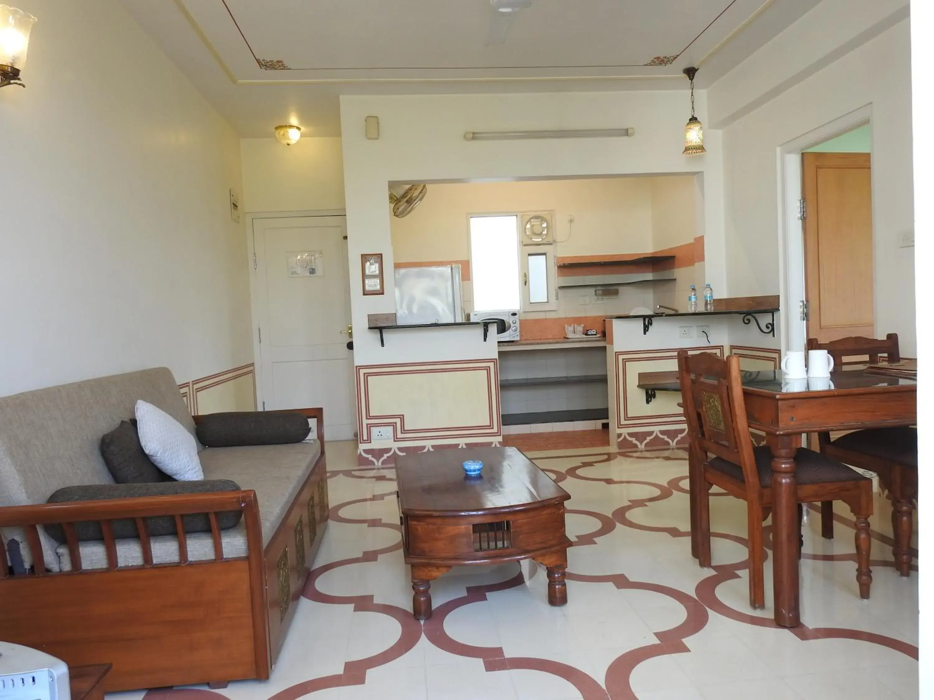 Living room, Kitchen/Kitchenette in Om Niwas Suite Hotel