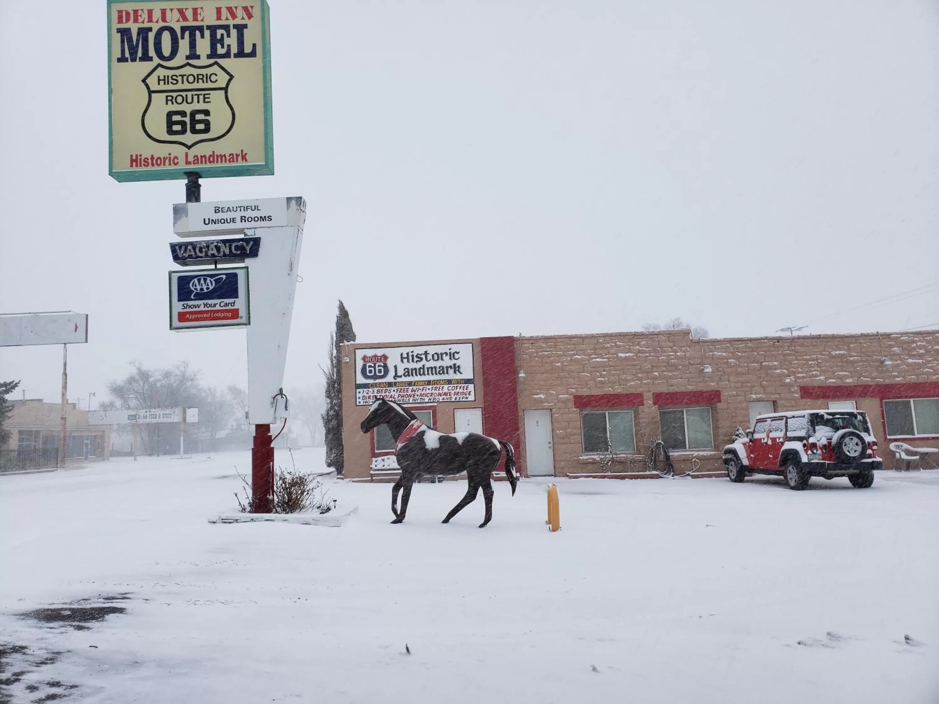Property logo or sign in Deluxe Inn