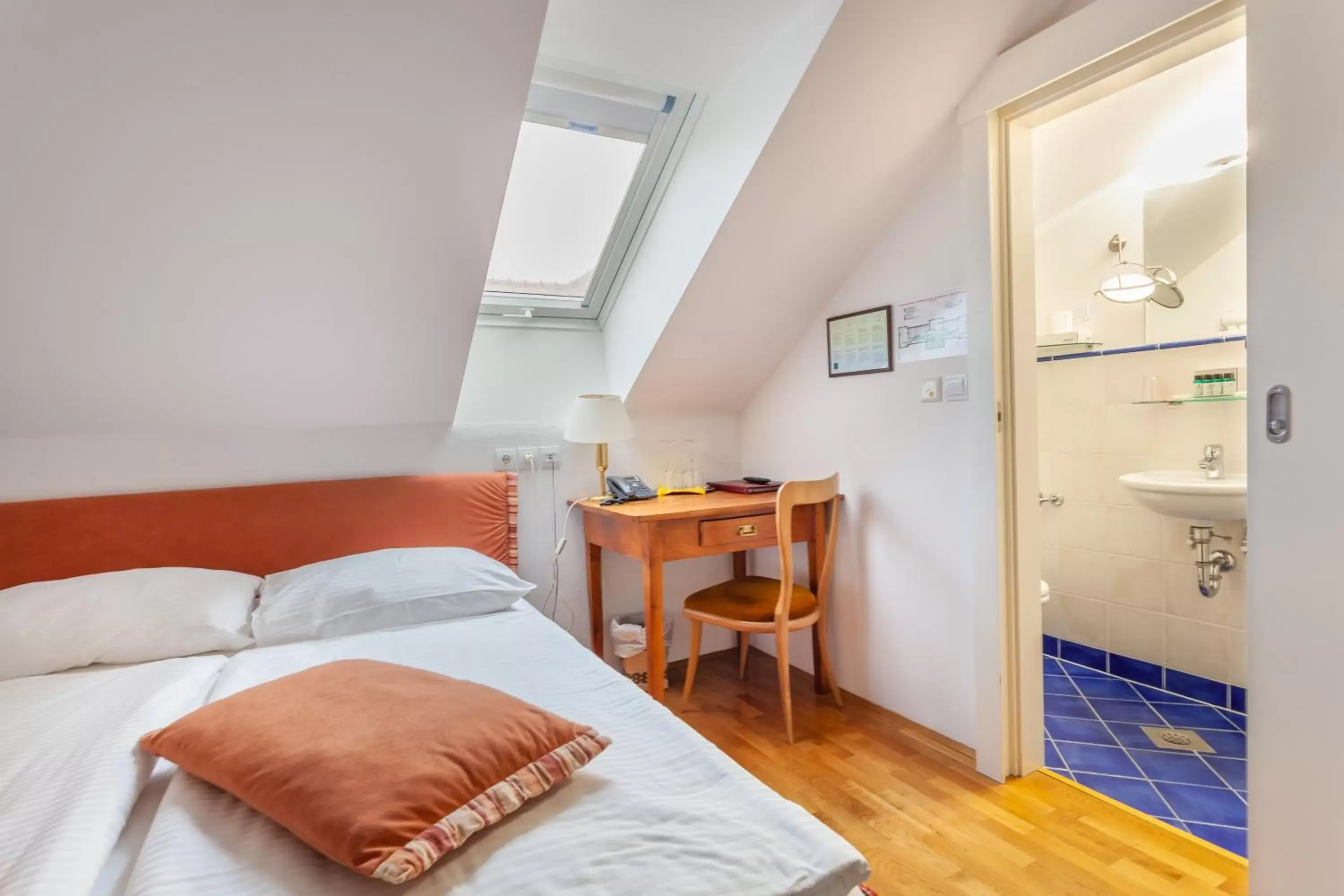 Bathroom, Bed in Hotel Triglav