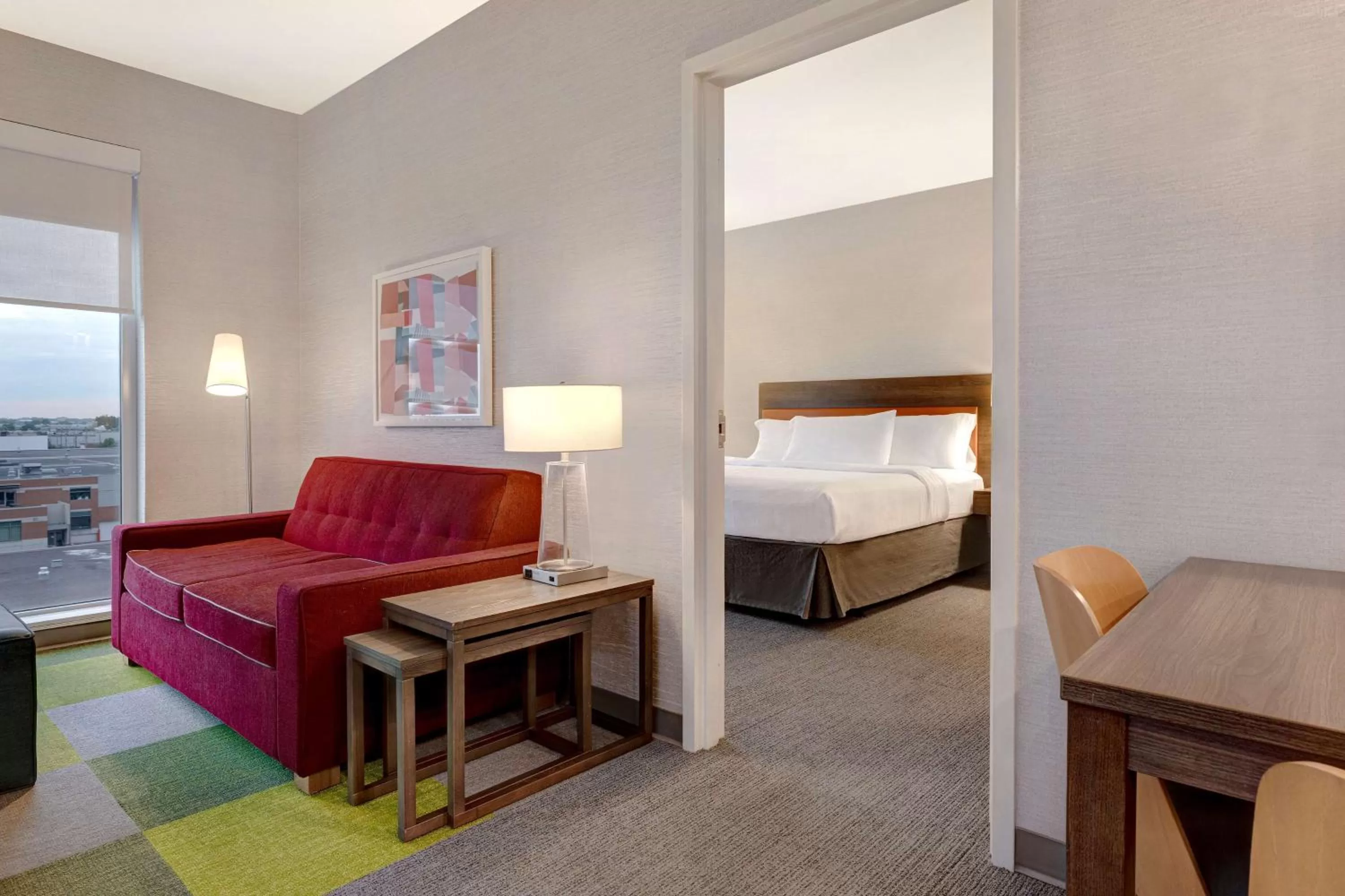 Living room, Bed in Home2 Suites By Hilton Montreal Dorval