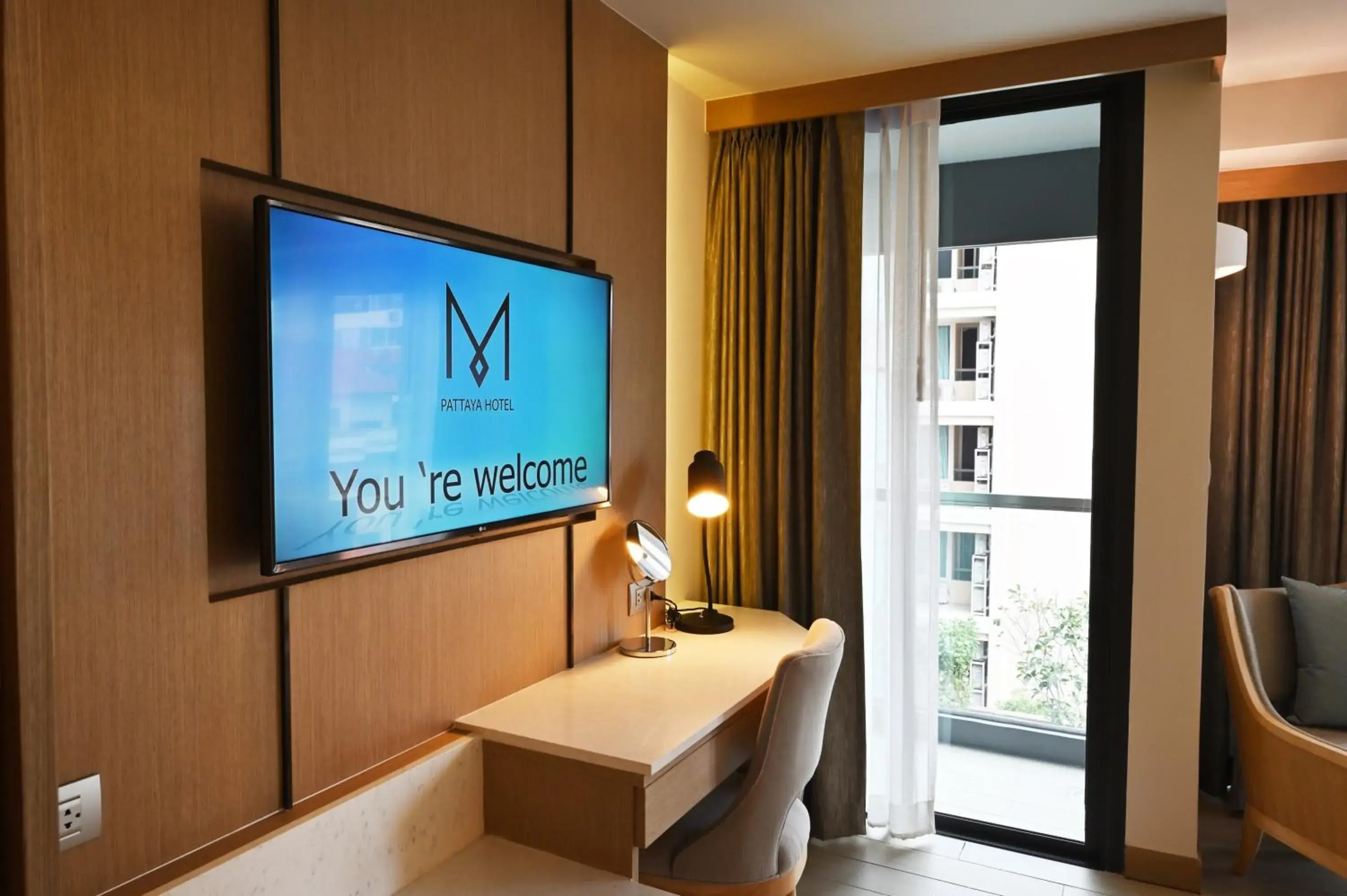 Pool view, TV/Entertainment Center in M Pattaya Hotel - SHA Extra Plus