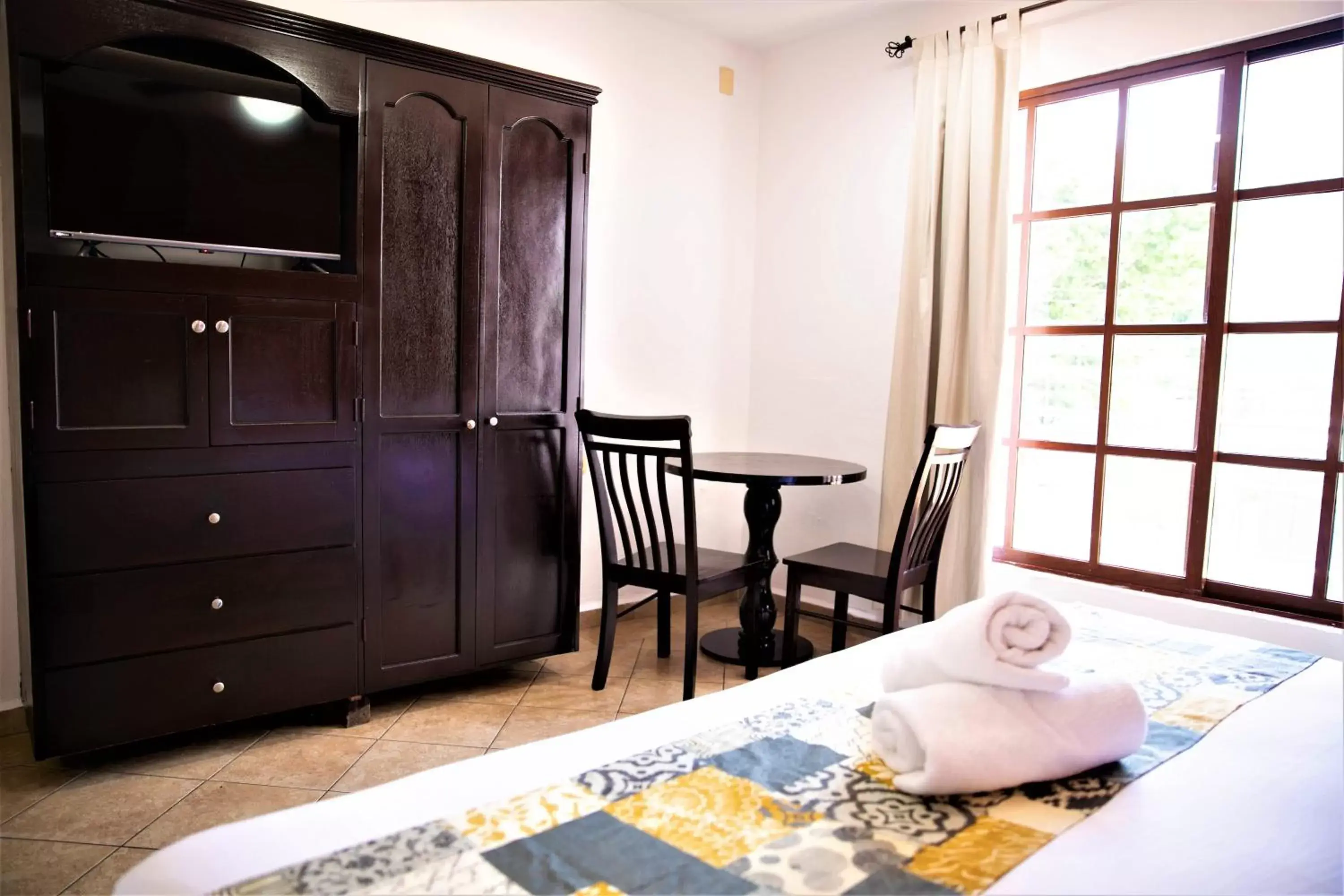 Photo of the whole room, TV/Entertainment Center in Hotel Colonial Playa del Carmen