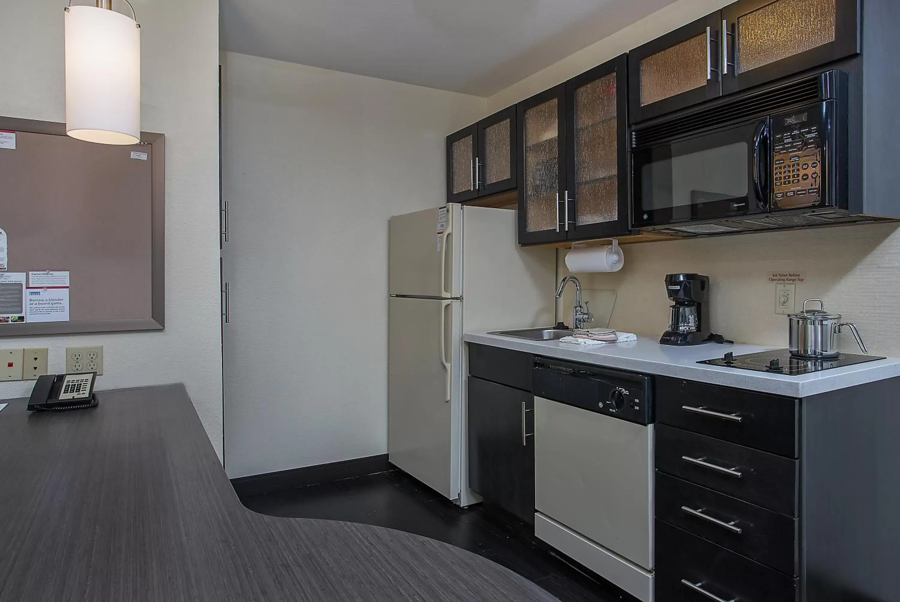 Bedroom, Kitchen/Kitchenette in Candlewood Suites Louisville Airport, an IHG Hotel