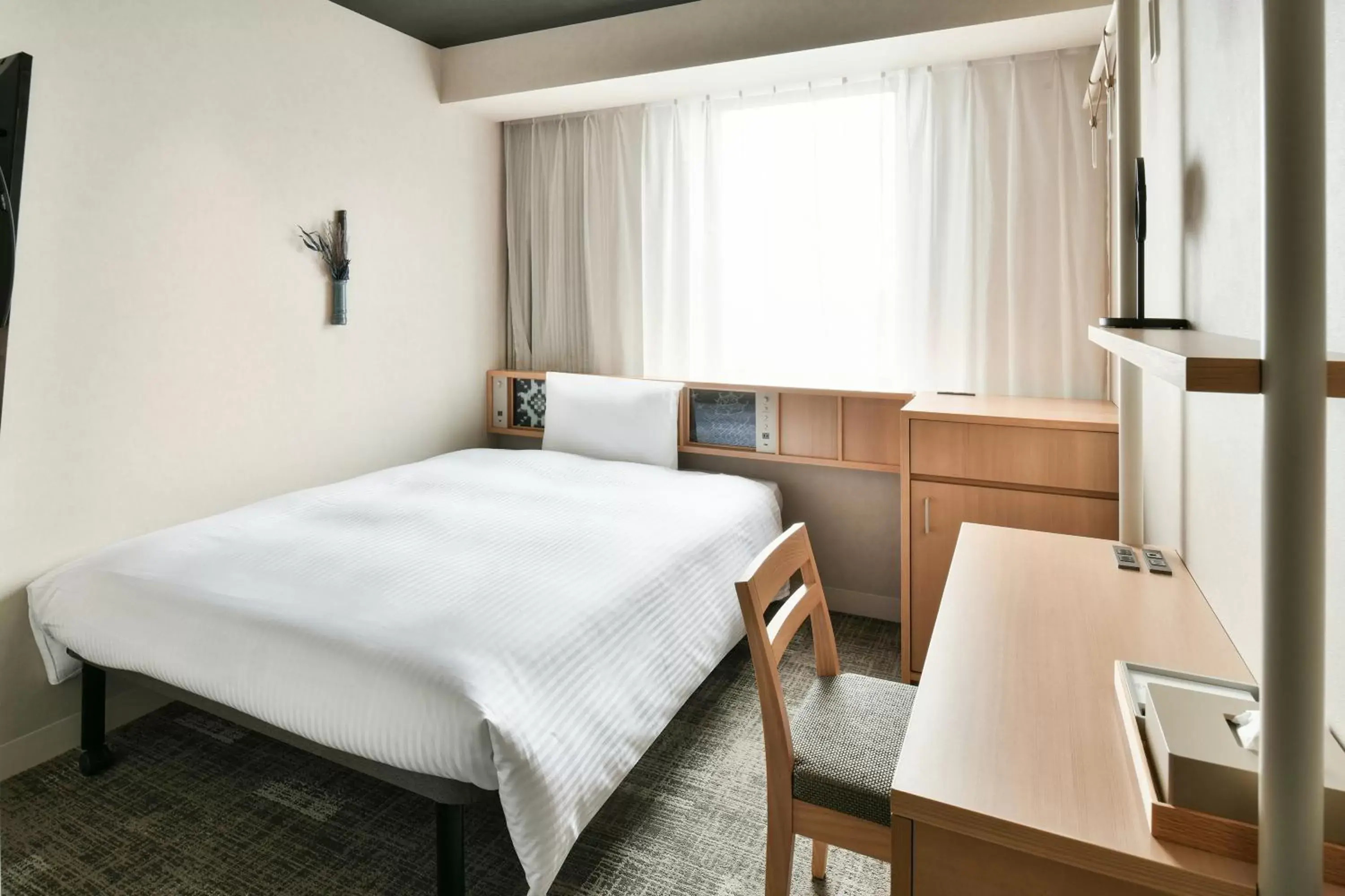 Bed in REF Matsuyama City Station by VESSEL HOTELS