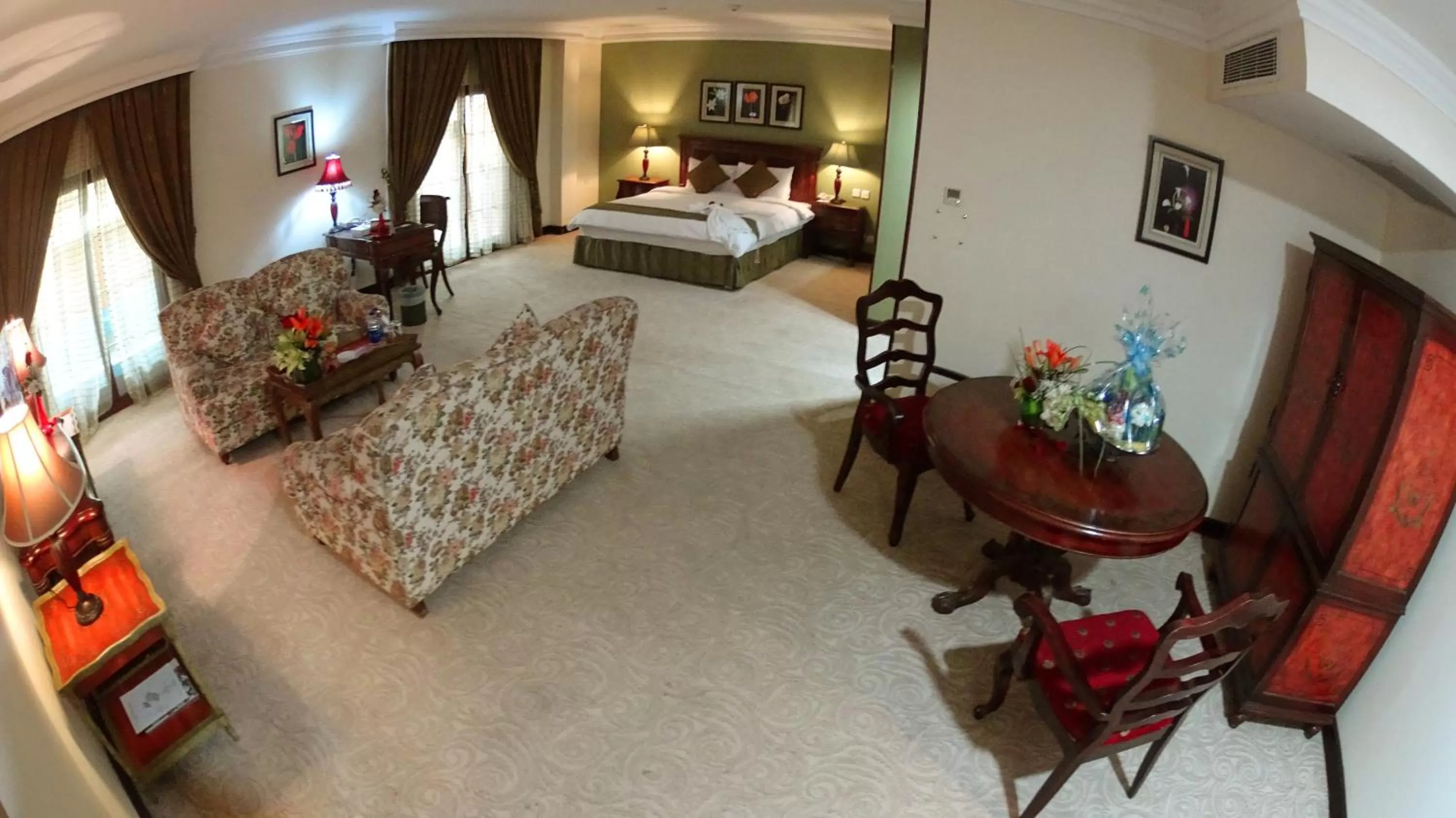 Living room, Bed in The Convention Center & Royal Suites Hotel