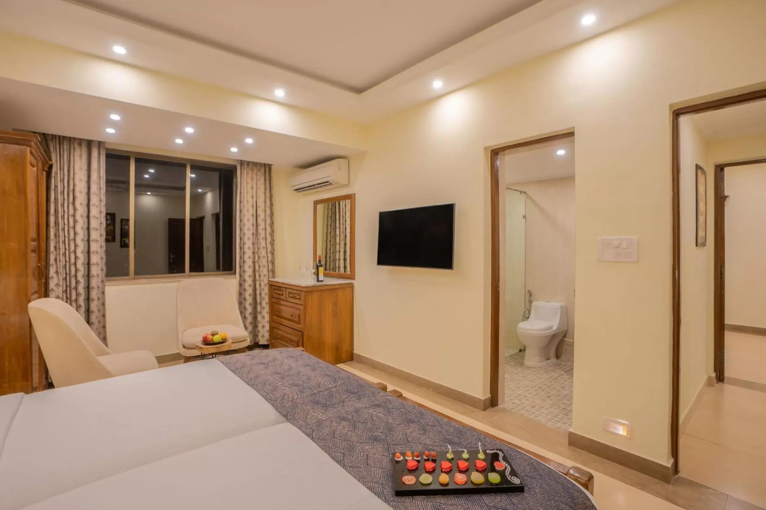 Bedroom, TV/Entertainment Center in De Mandarin Beach Resort Suites & Villas, Candolim