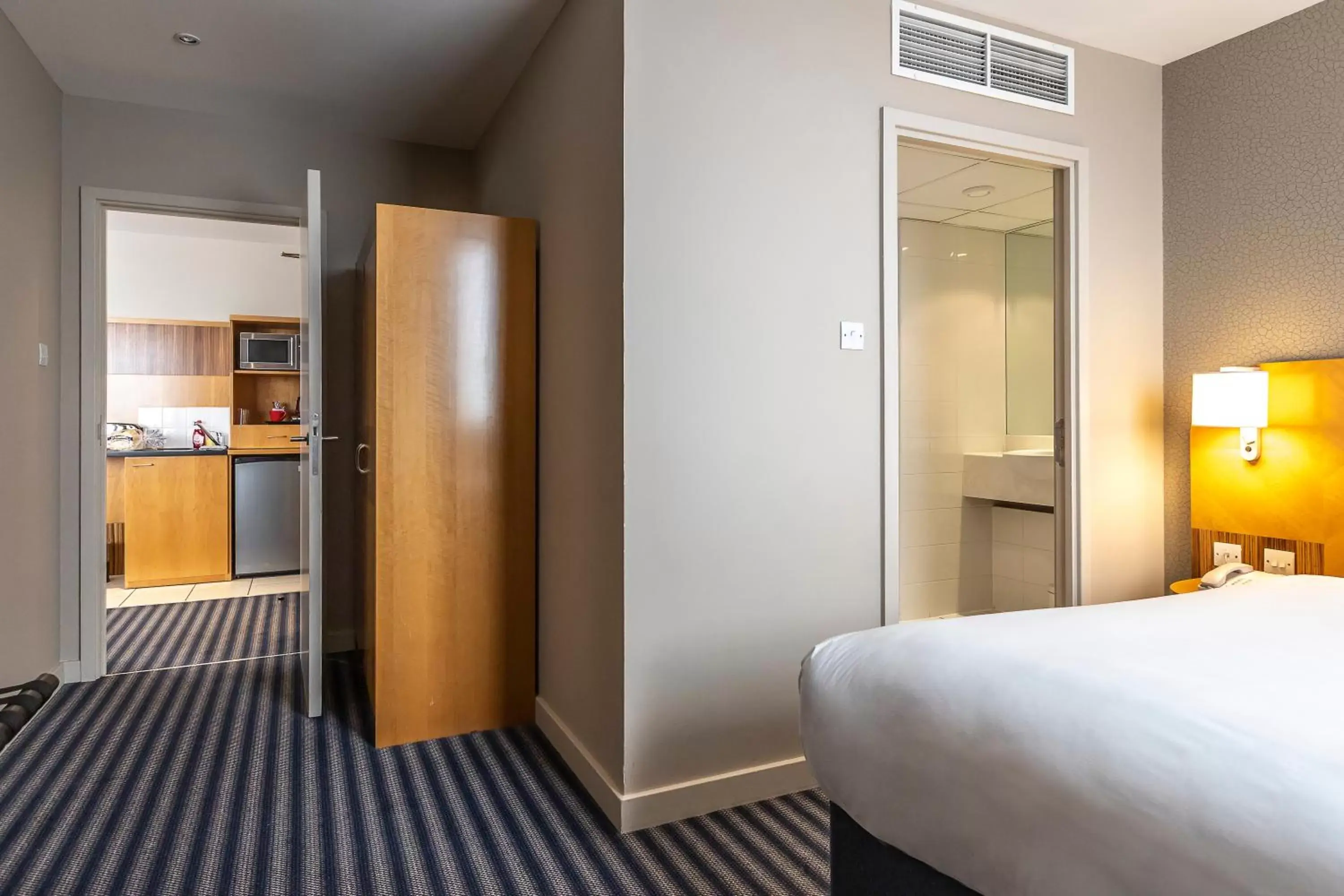 Bed in Ramada Hotel & Suites by Wyndham Coventry