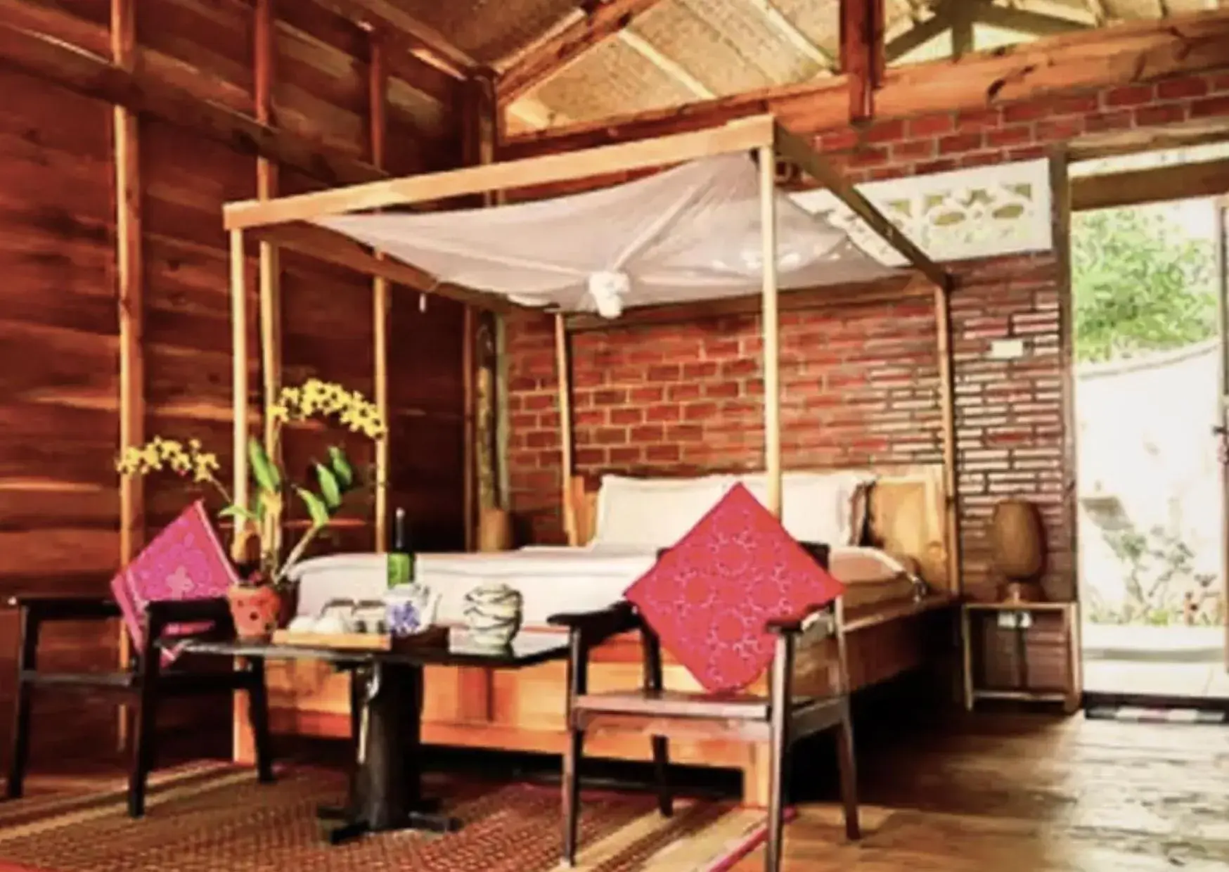 Bed, Seating Area in Bamboo Cottages