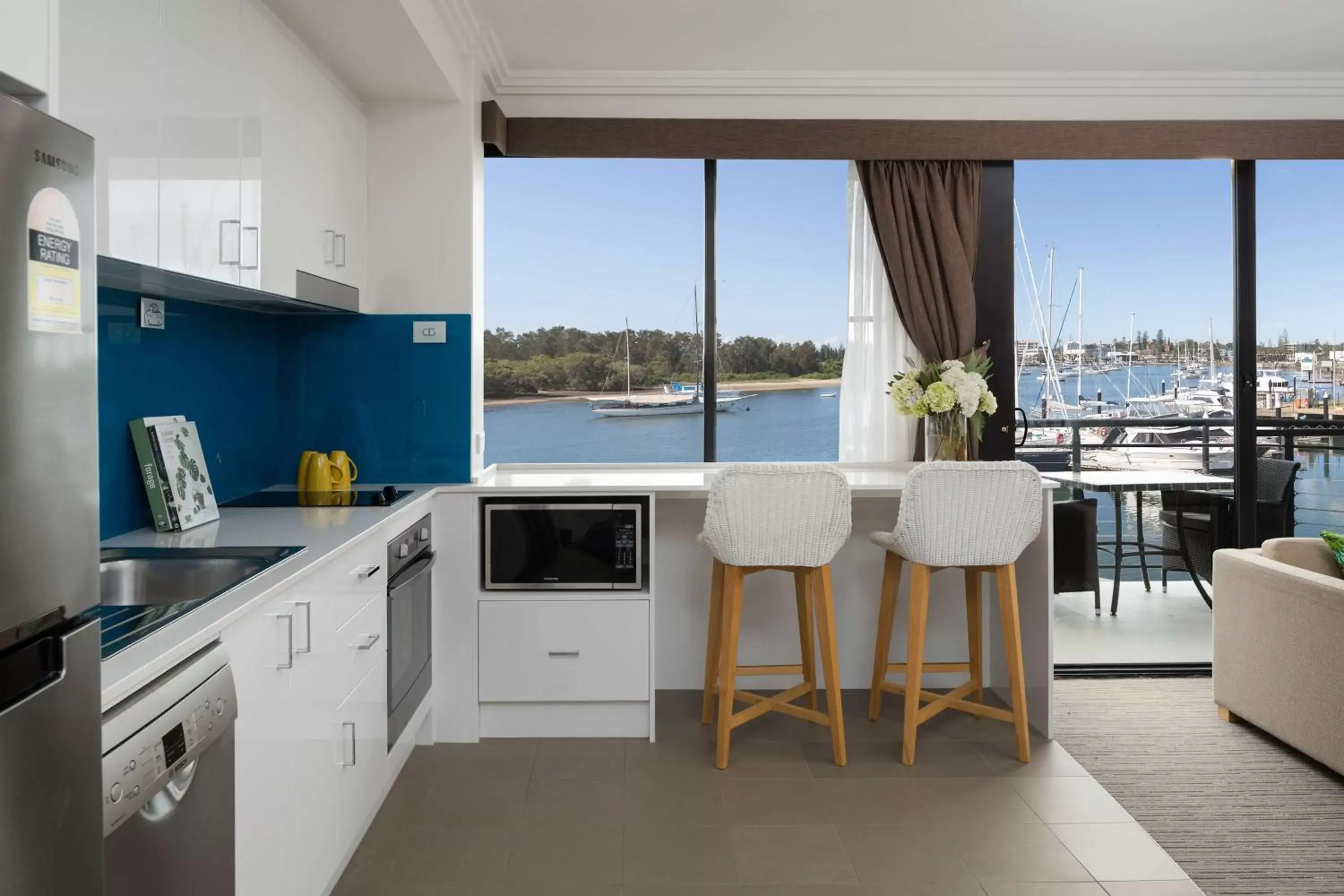 Living room, Kitchen/Kitchenette in Sails Port Macquarie by Rydges