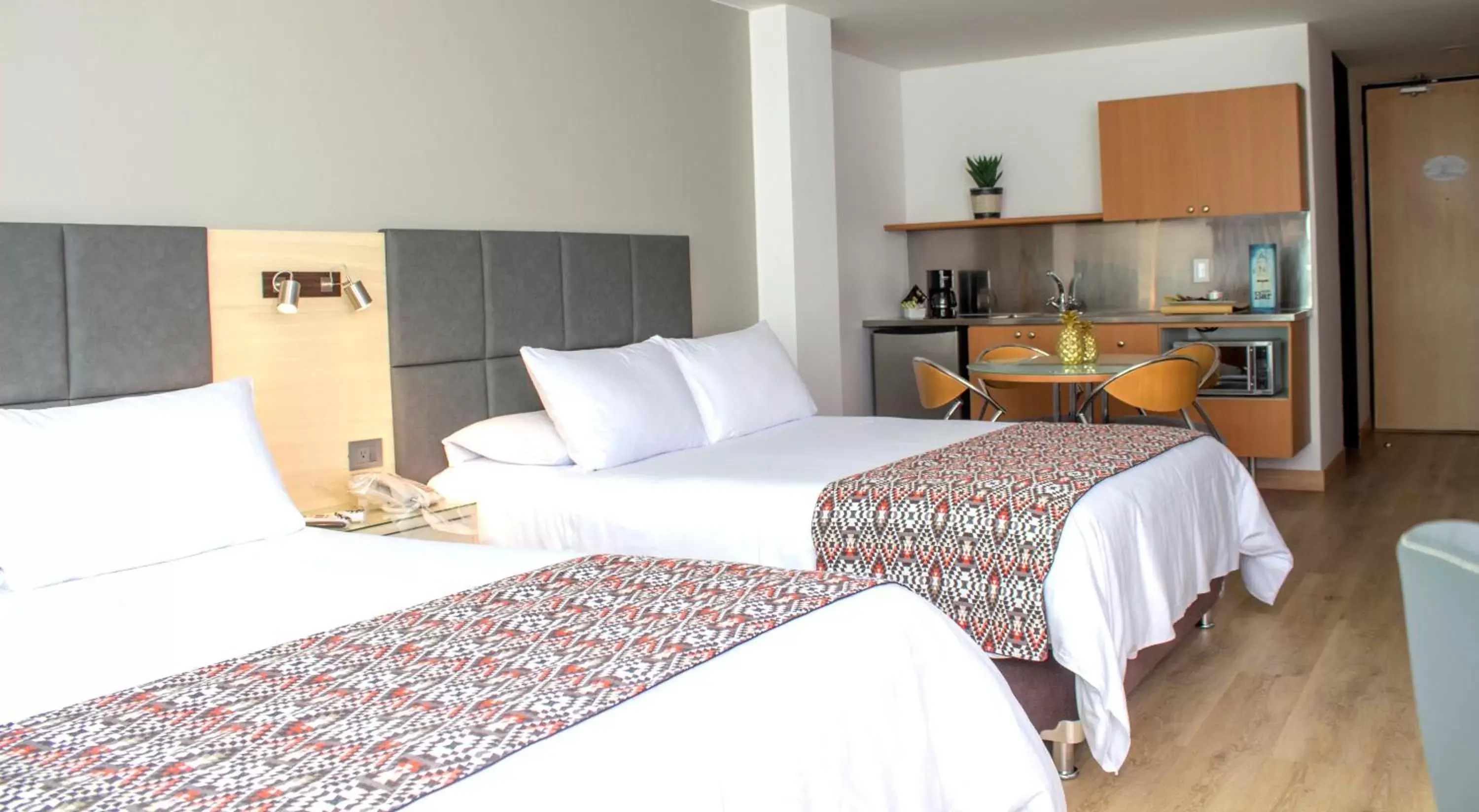 Kitchen or kitchenette, Bed in Novelty Suites Hotel