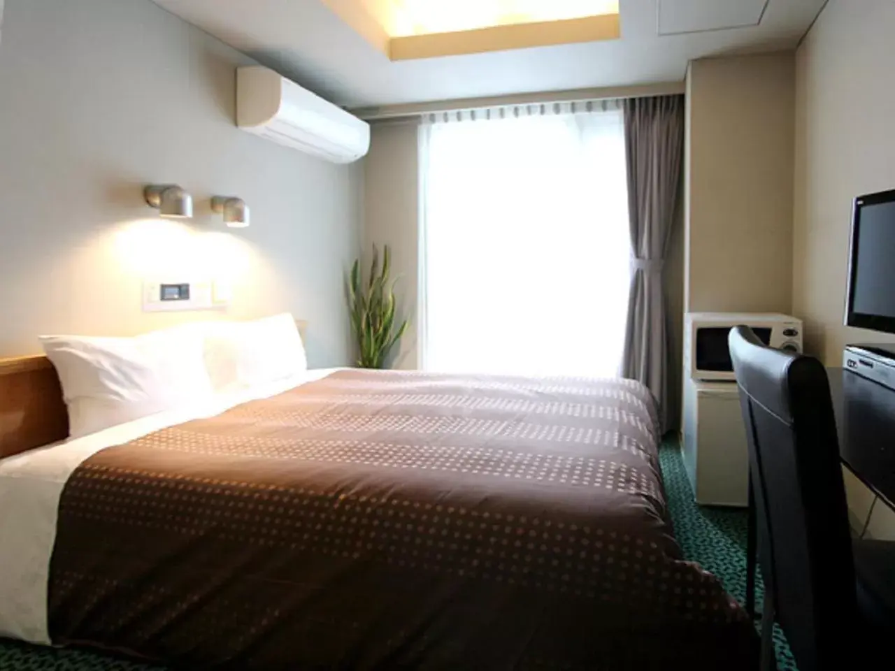 Bed in HOTEL LiVEMAX BUDGET Yumoto