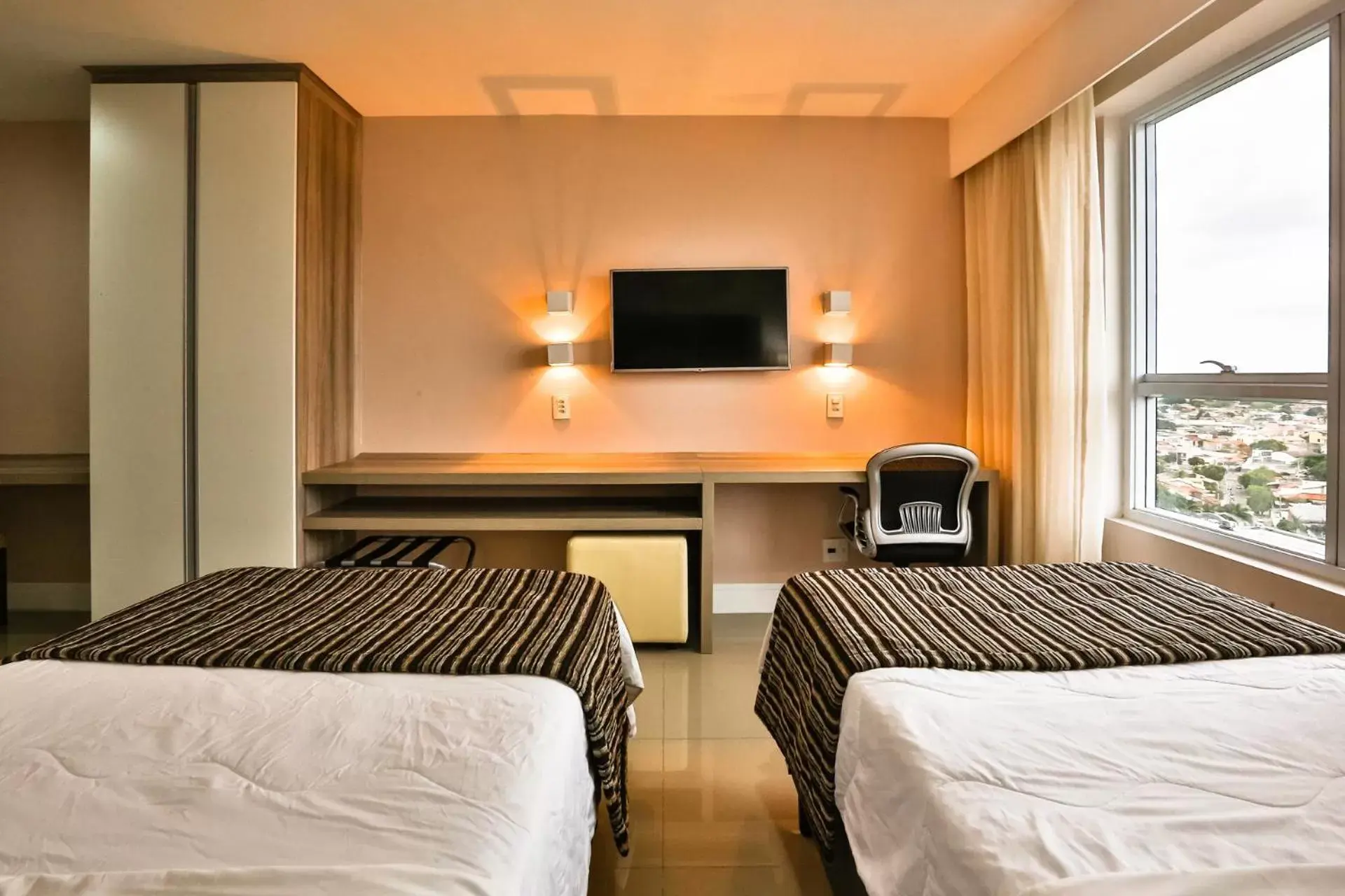 Bed in Ramada Hotel & Suites Campos Pelinca