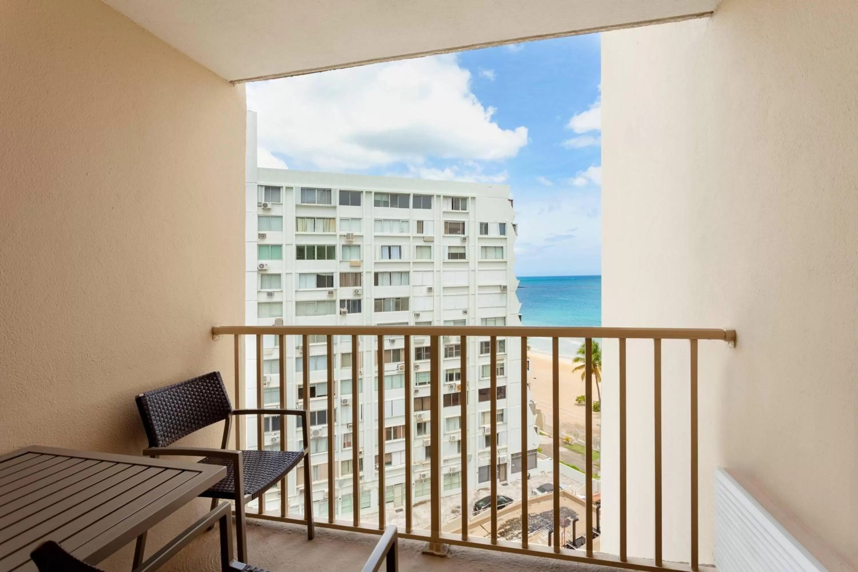 Queen Room with Two Queen Beds, Balcony and Partial Ocean View - Hearing Accessible in Courtyard by Marriott Isla Verde Beach Resort