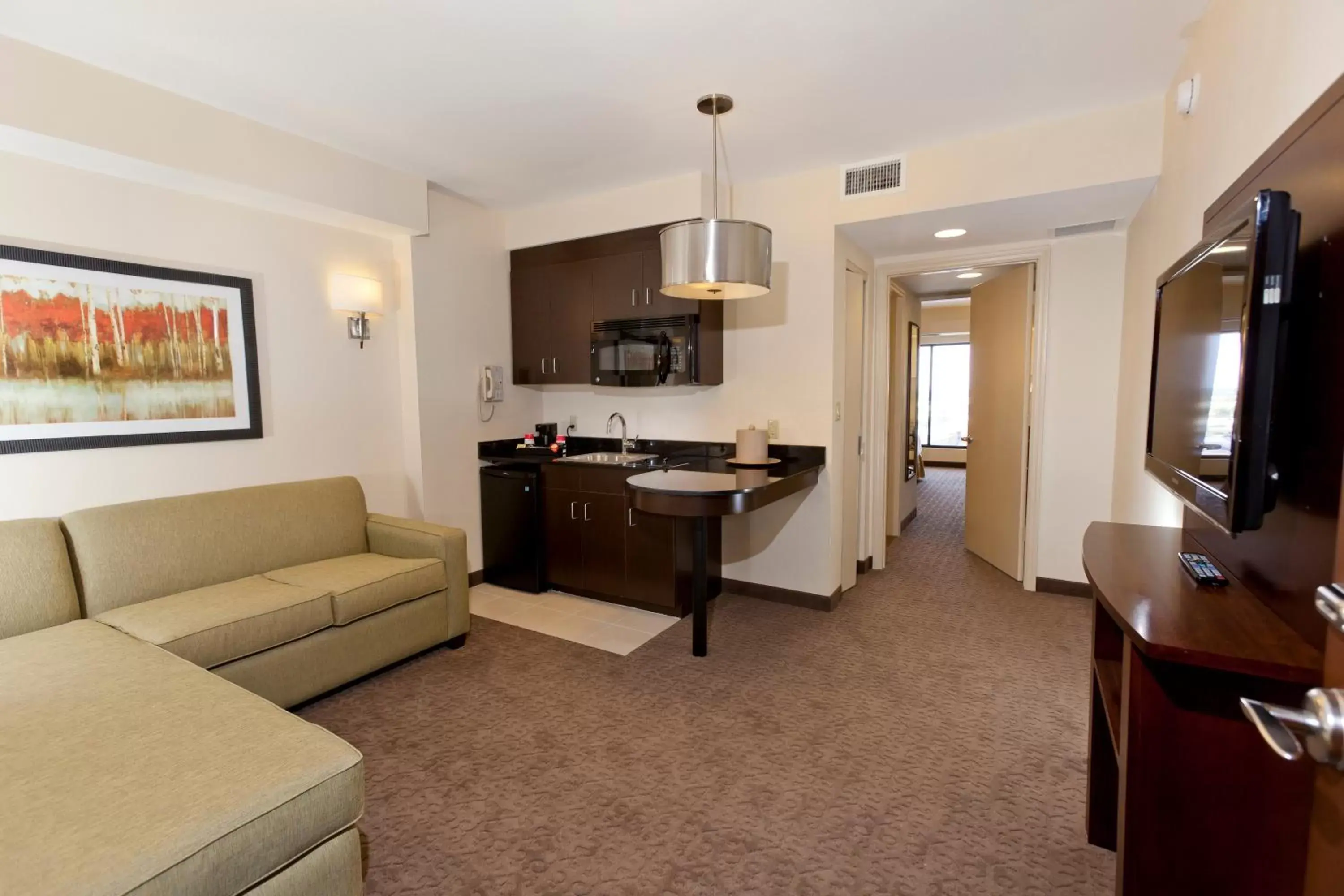 Kitchen or kitchenette, Seating Area in Ramada Suites By Wyndham Orlando International Drive