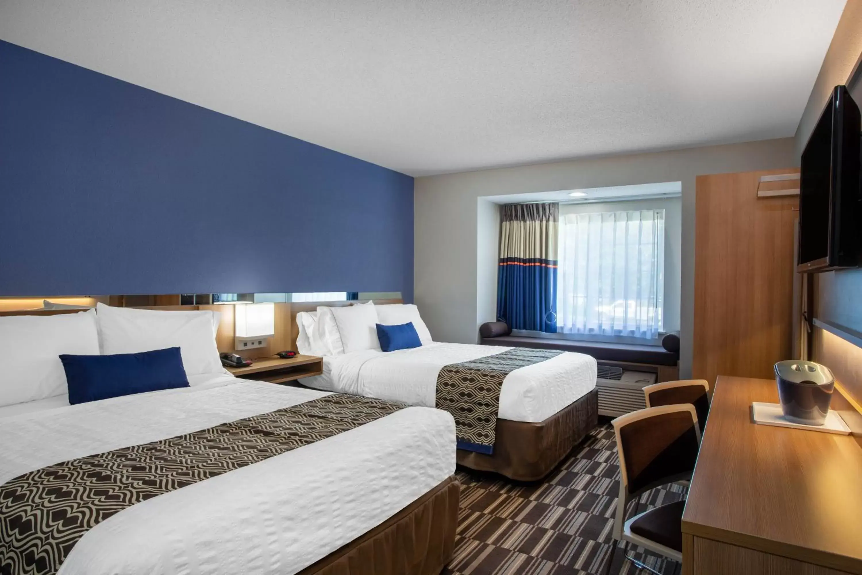 Bed in Microtel Inn & Suites by Wyndham Burlington