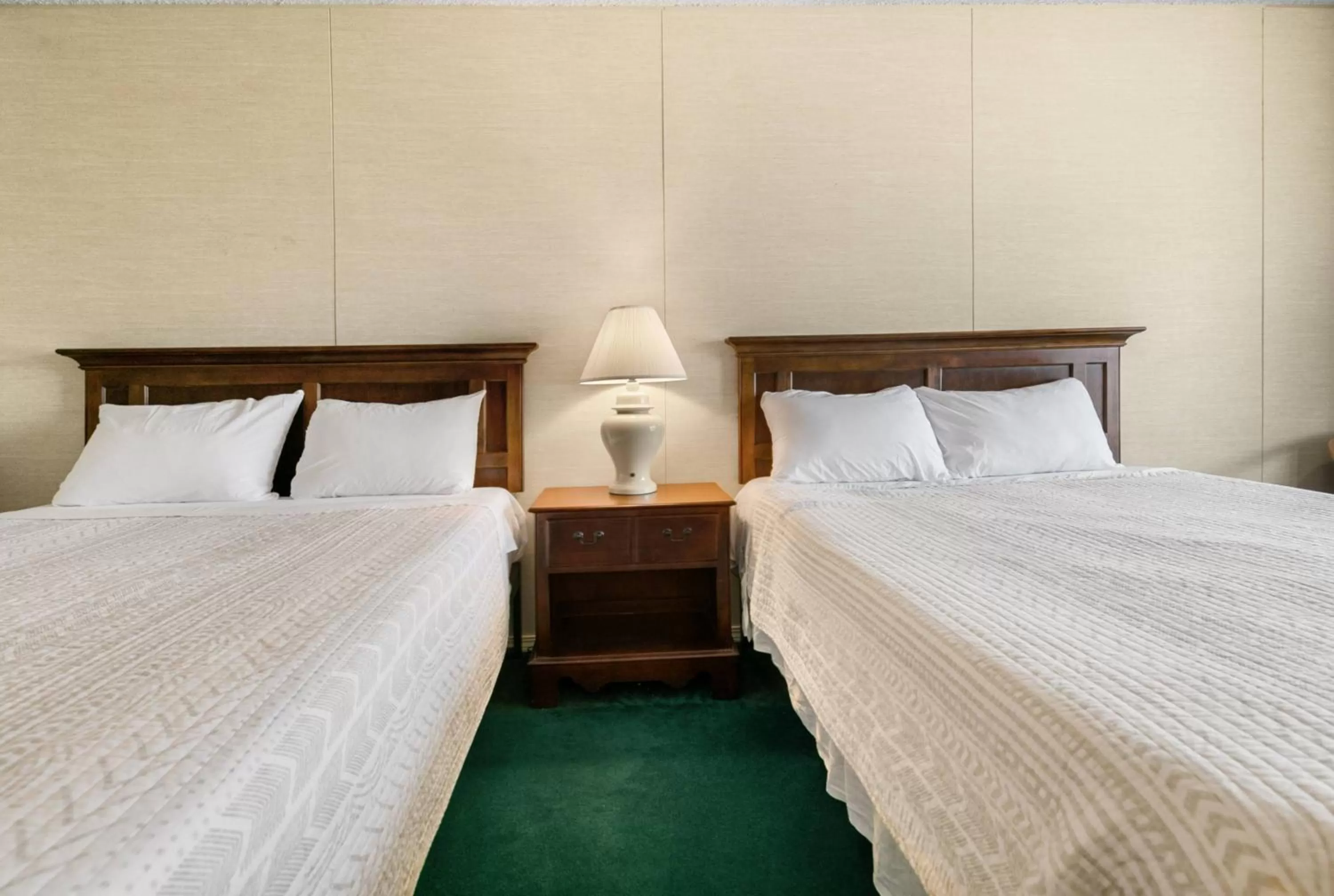 Bed in Candlewick Inn and Suites