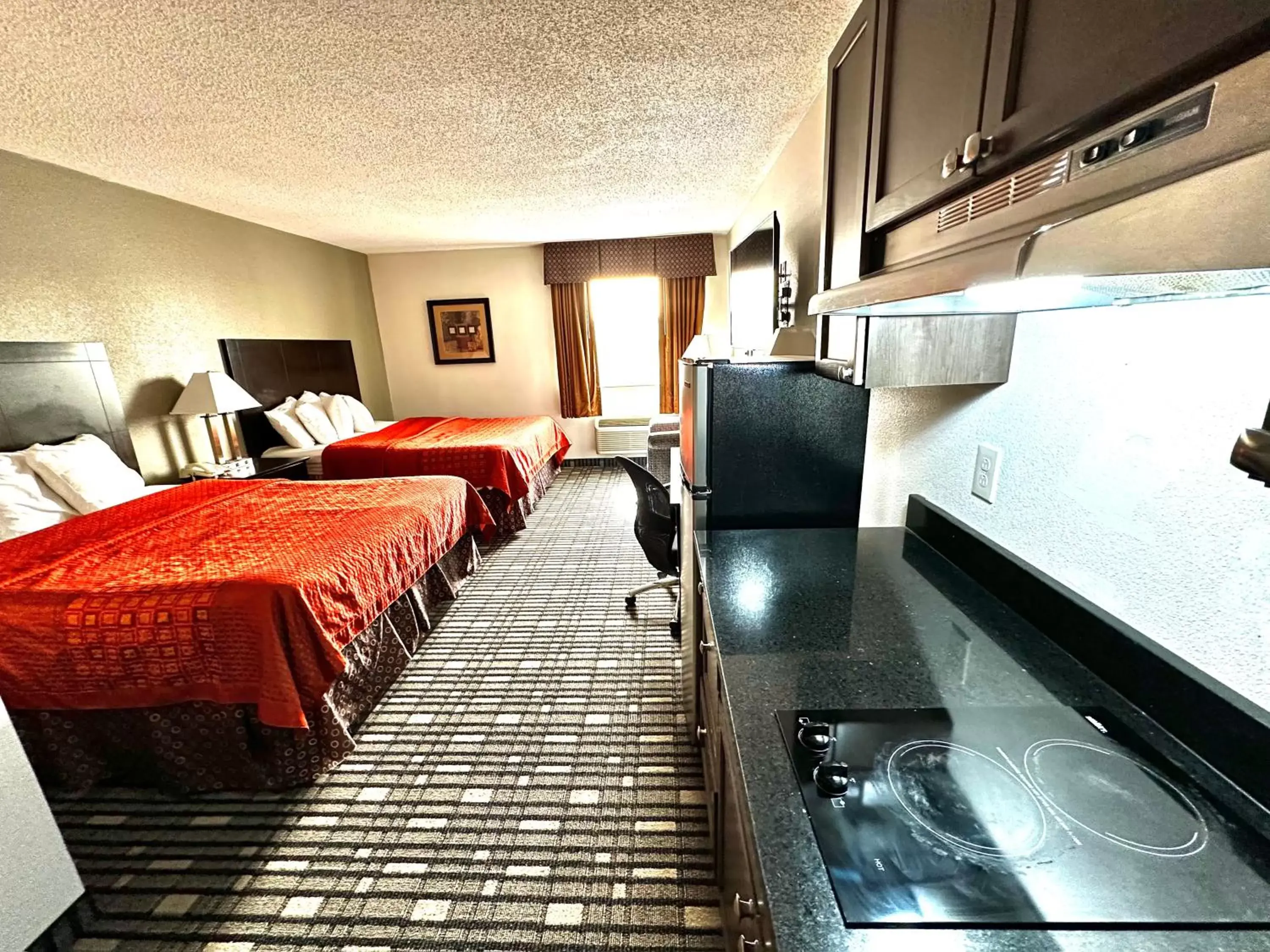 Guests, TV/Entertainment Center in SureStay Plus Hotel by Best Western Lubbock Medical Center