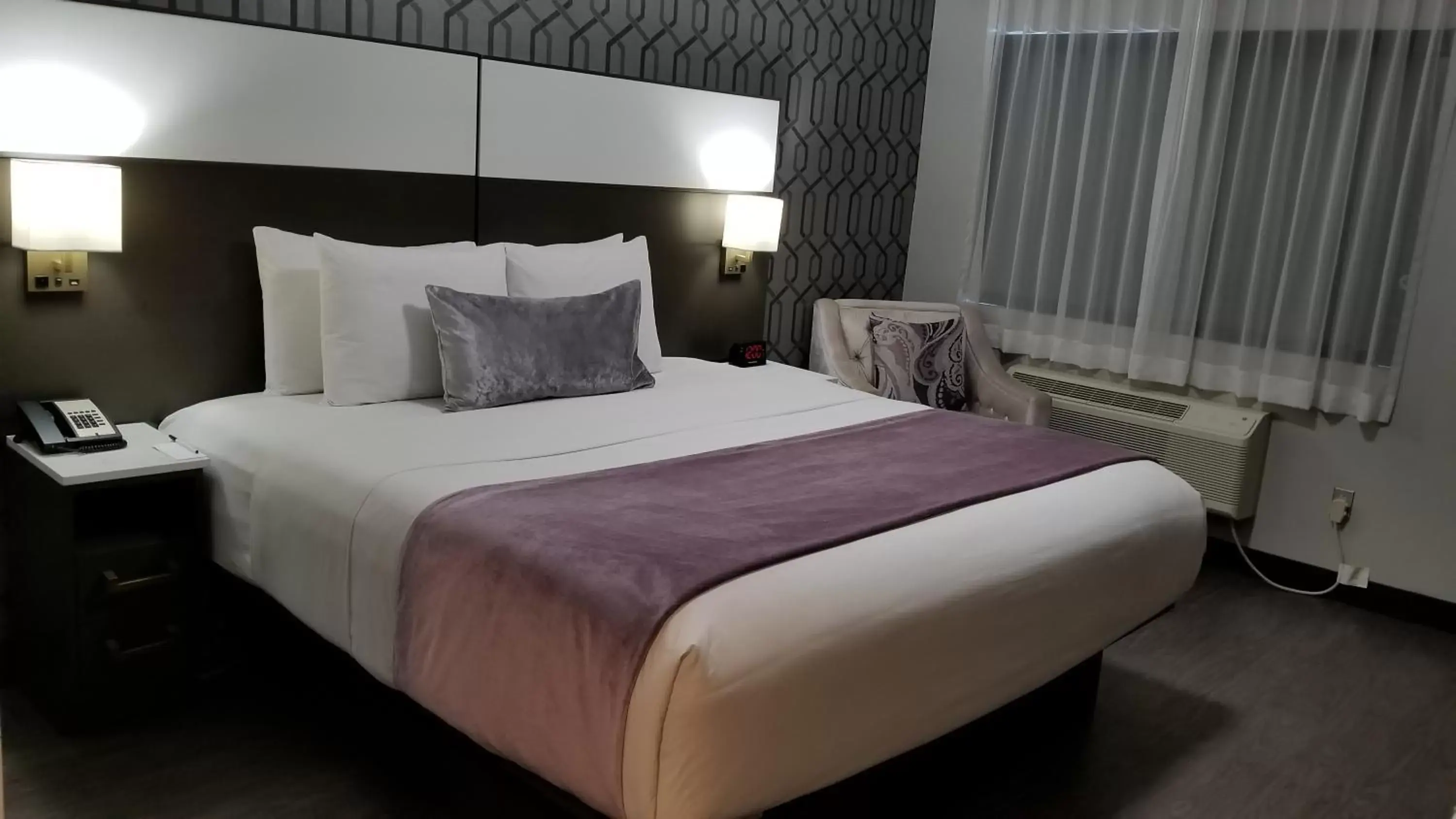 Bed in Sunset West Hotel, SureStay Collection By Best Western