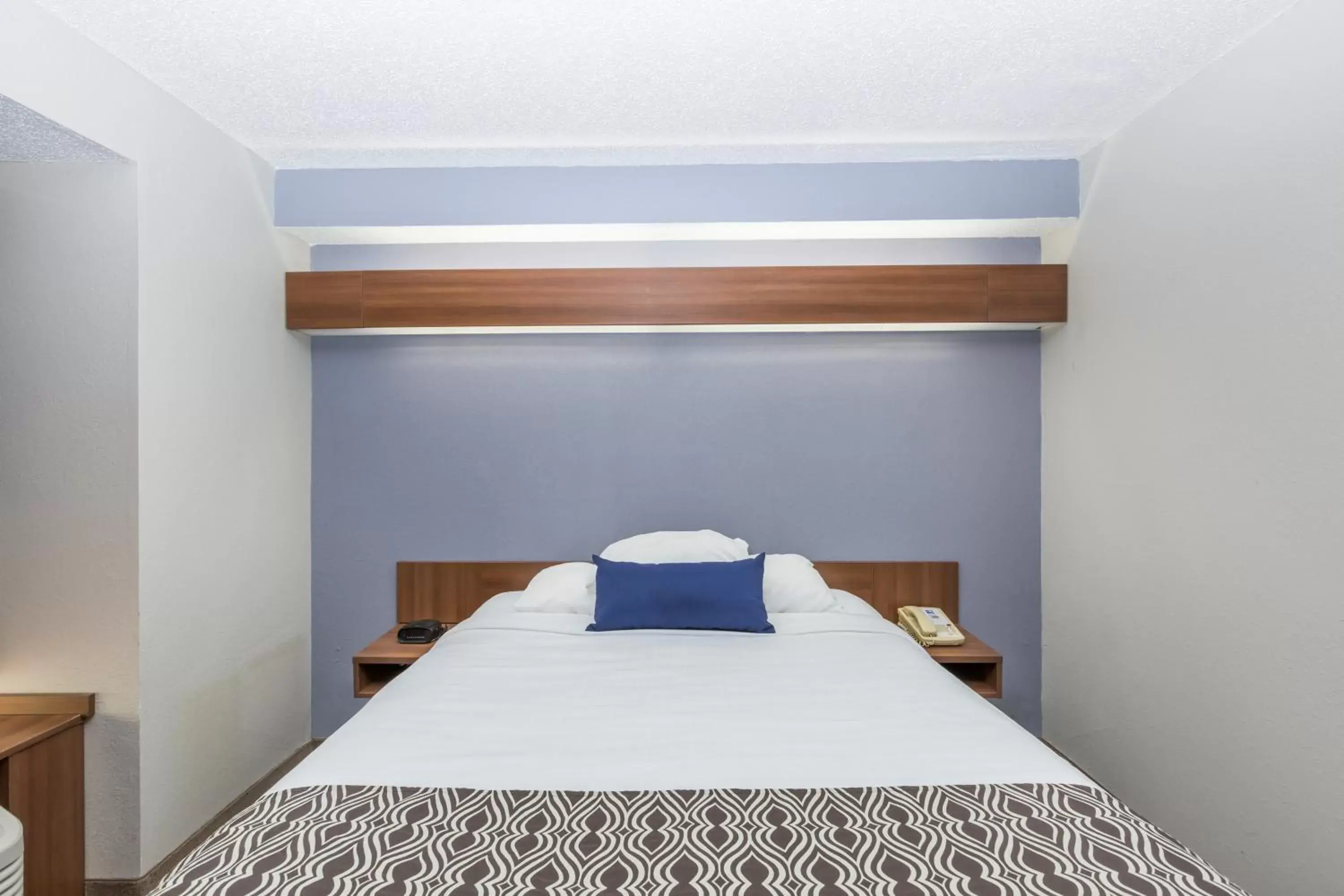 Bed in Microtel Inn & Suites by Wyndham Sioux Falls
