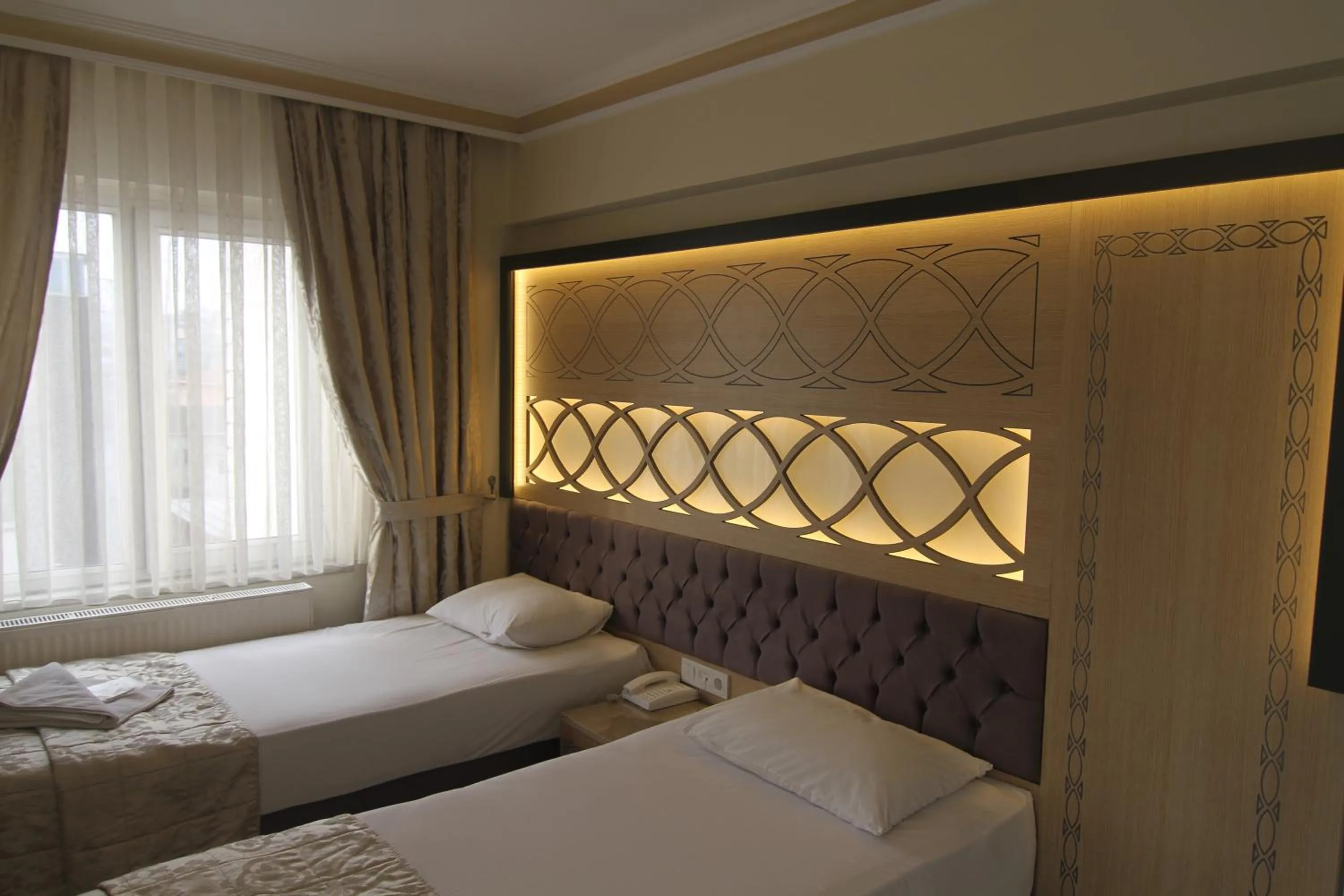 Bed in Grand Liza Hotel