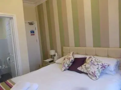 Bed in Harry's Hotel & Restaurant