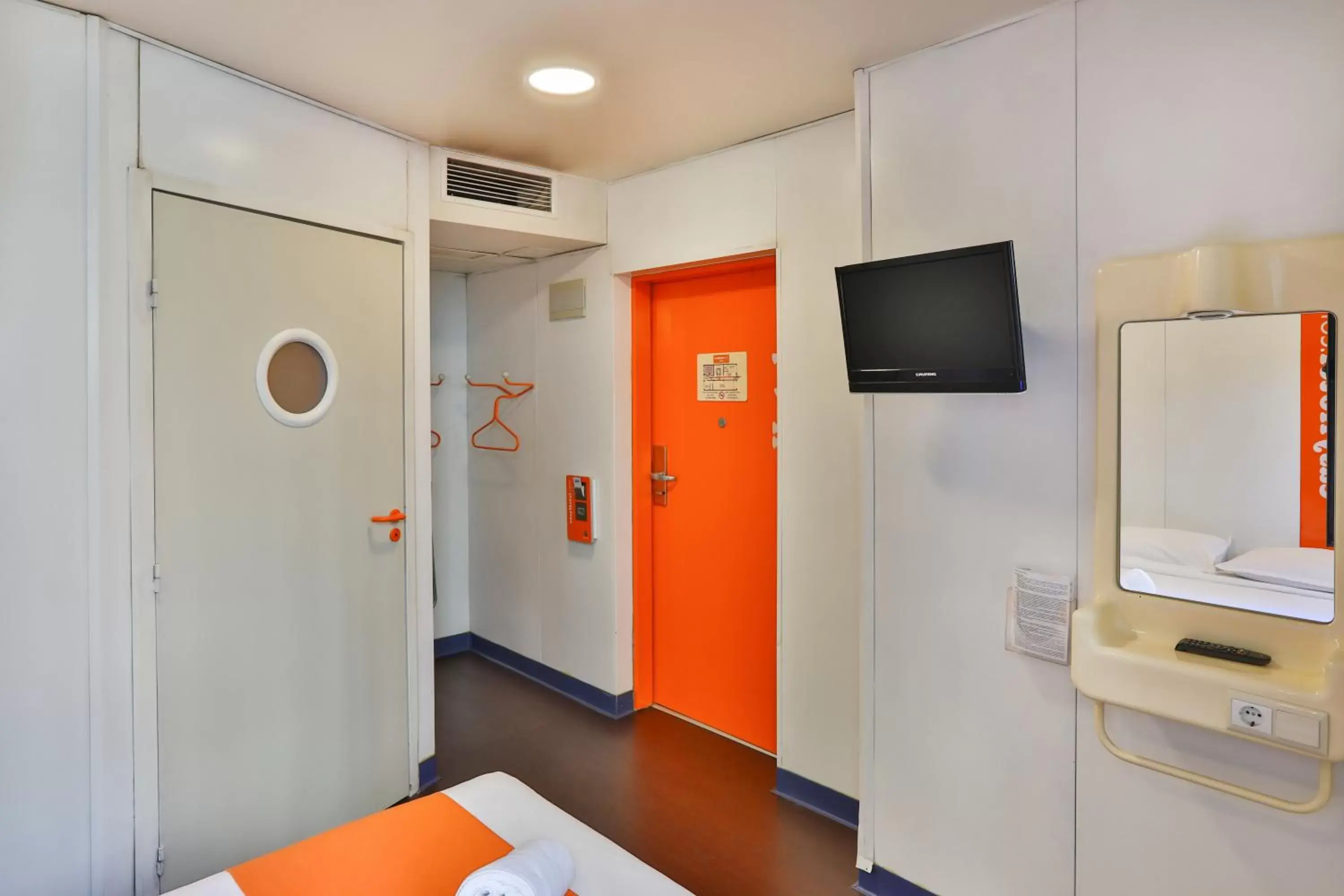 Photo of the whole room, TV/Entertainment Center in easyHotel Sofia