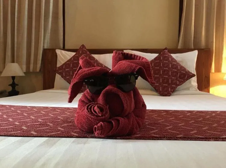 Bed in Uma Sari Cottage by Mahaputra-CHSE Certified