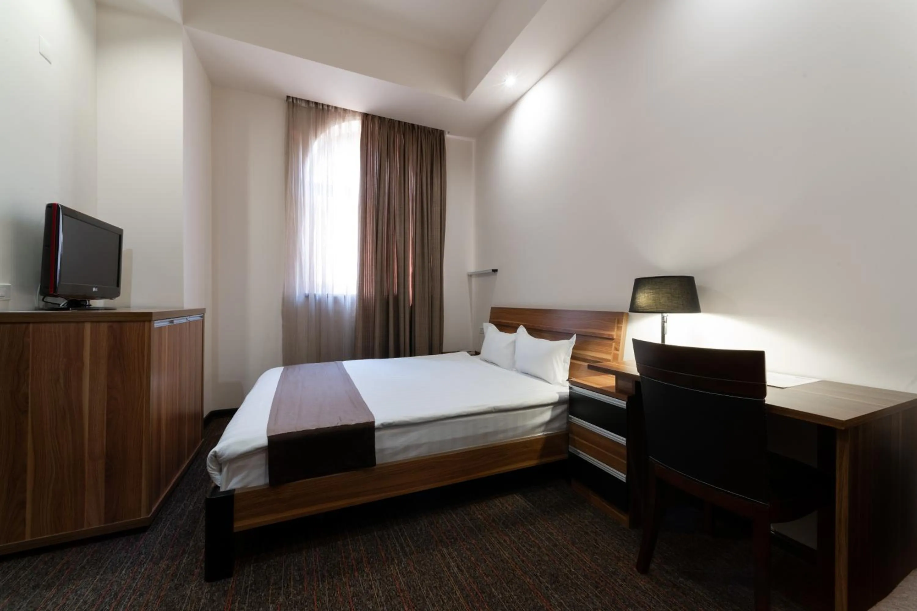 Living room, Bed in Bass Boutique Hotel