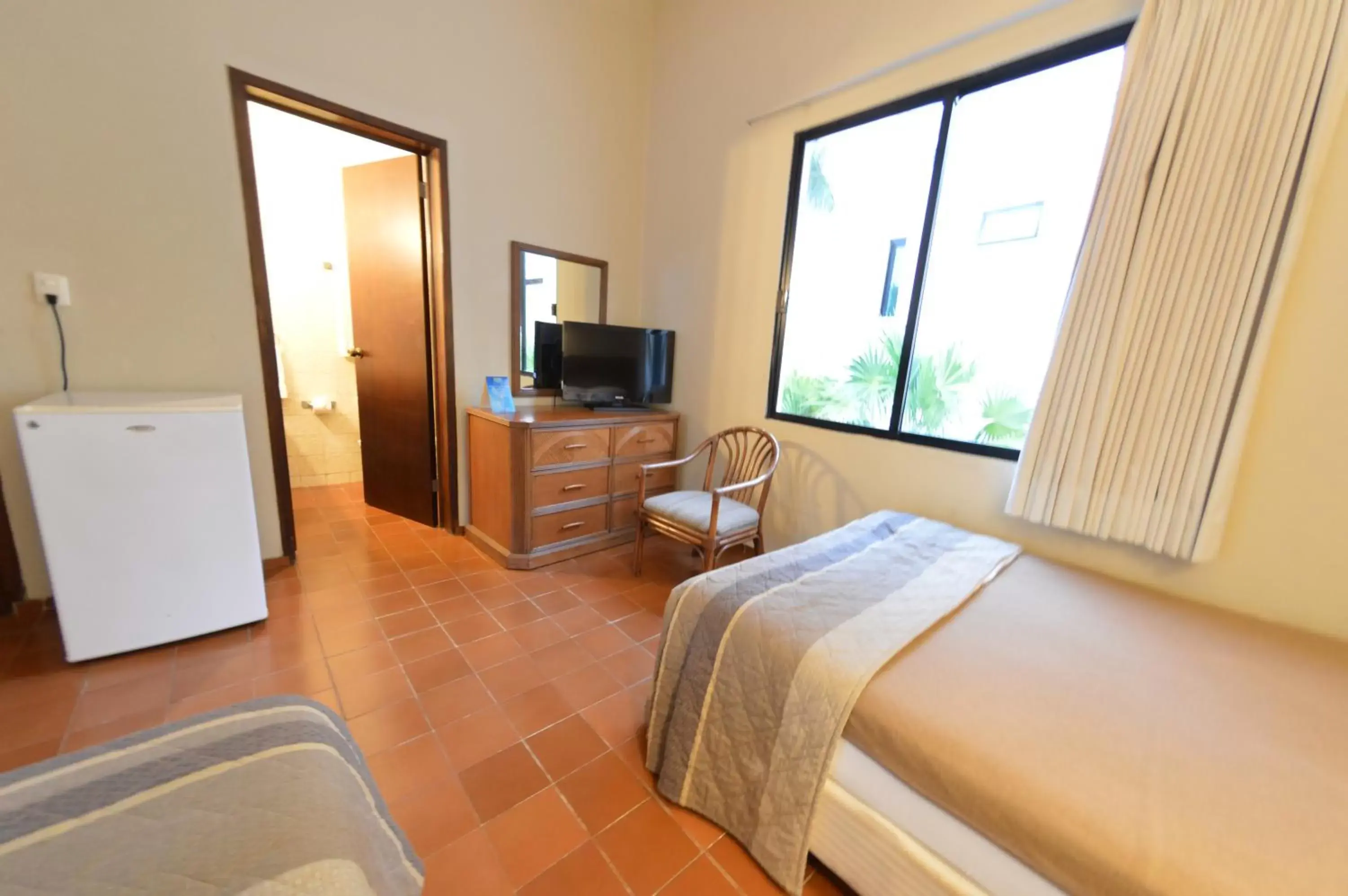 Bedroom, TV/Entertainment Center in Sina Suites