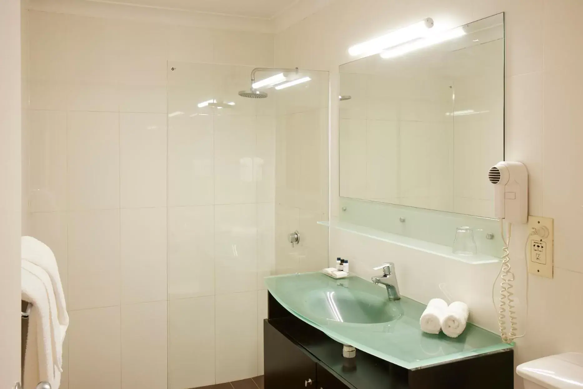 Bathroom in Ramada Hotel & Suites by Wyndham Cabramatta