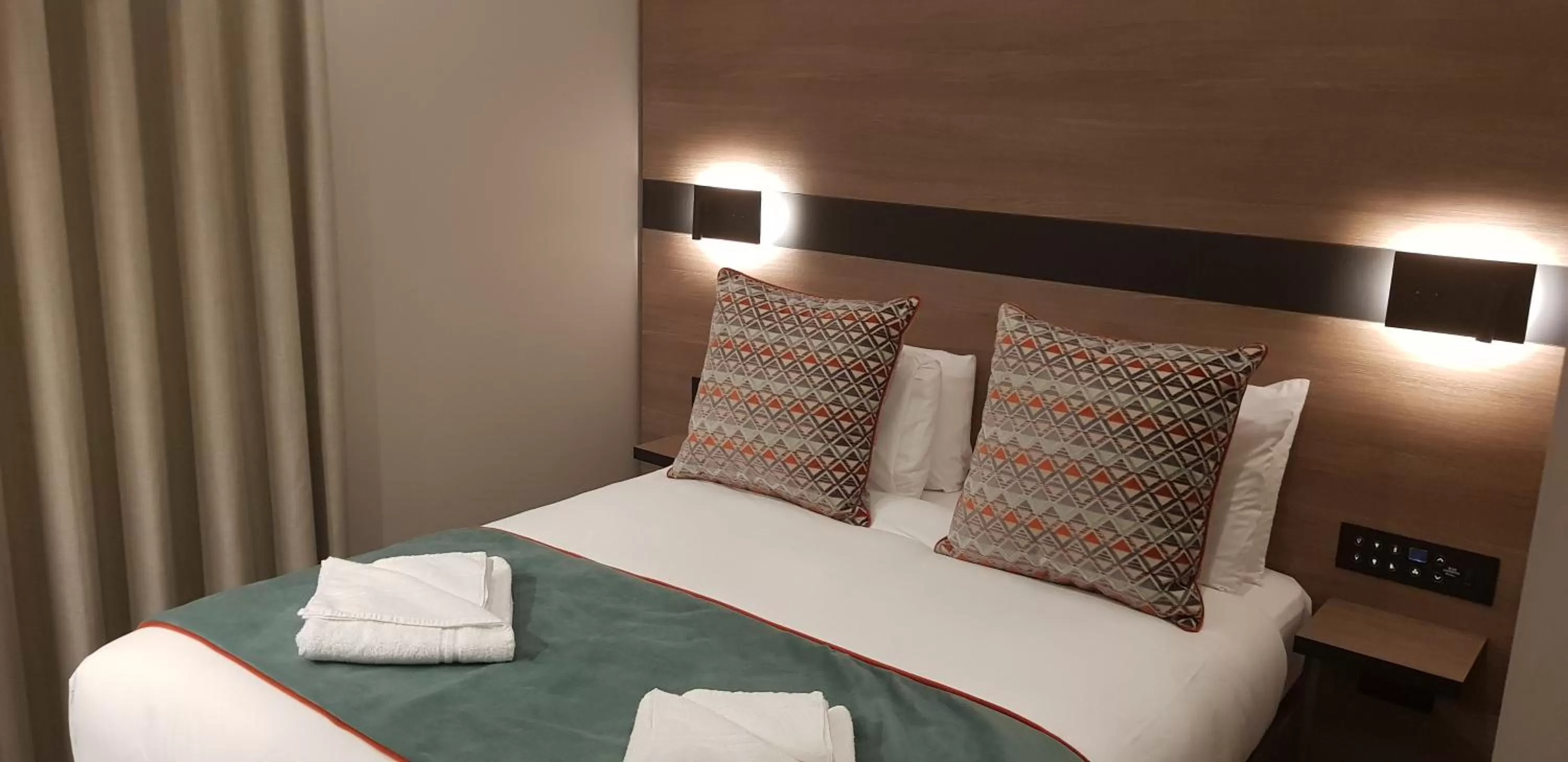 Bed in Merit Kensington Hotel