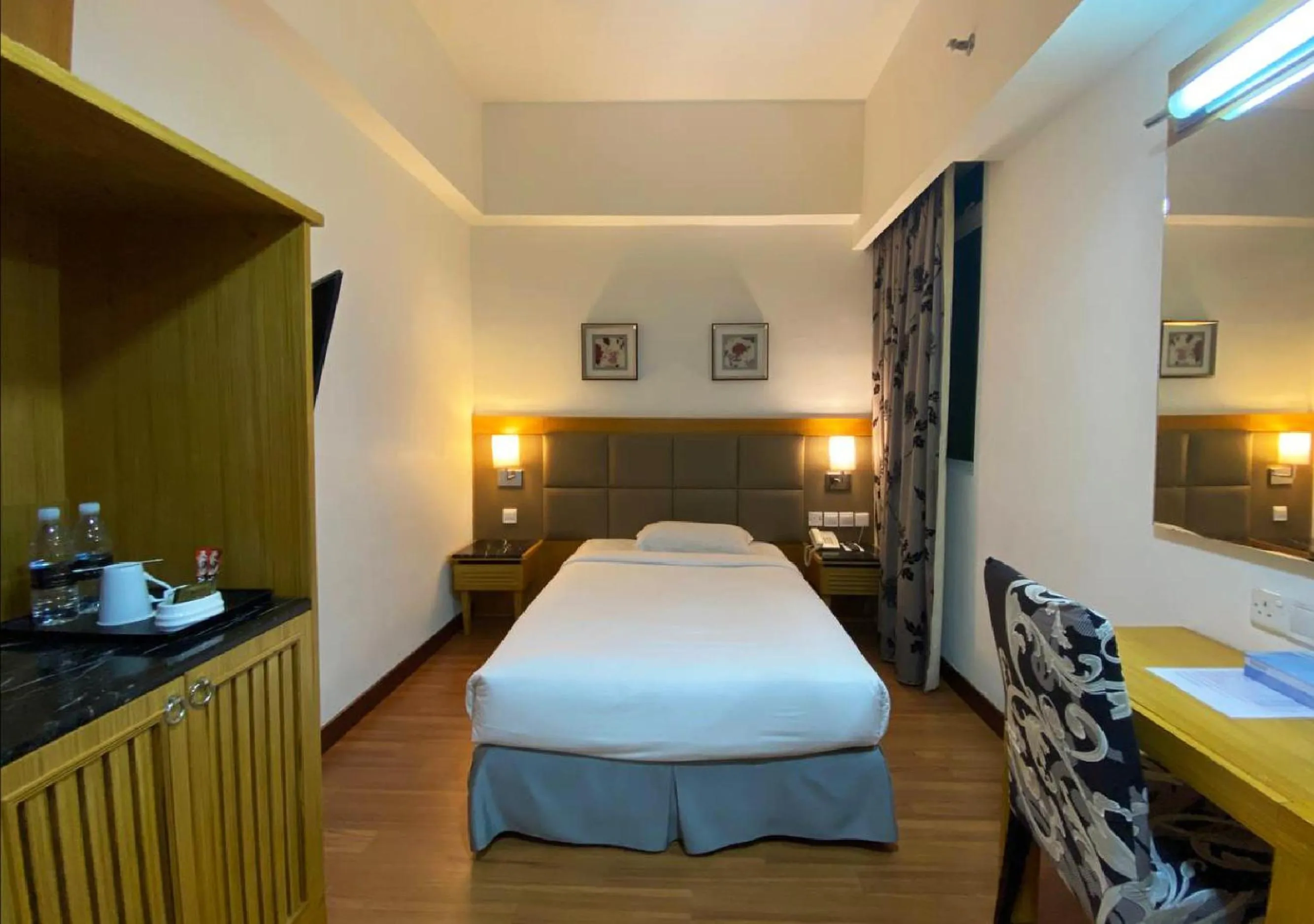 Bed in Crown Garden Hotel