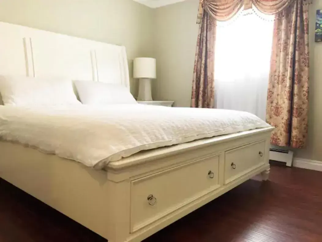 Bed in Jane's private rooms with shared washroom
