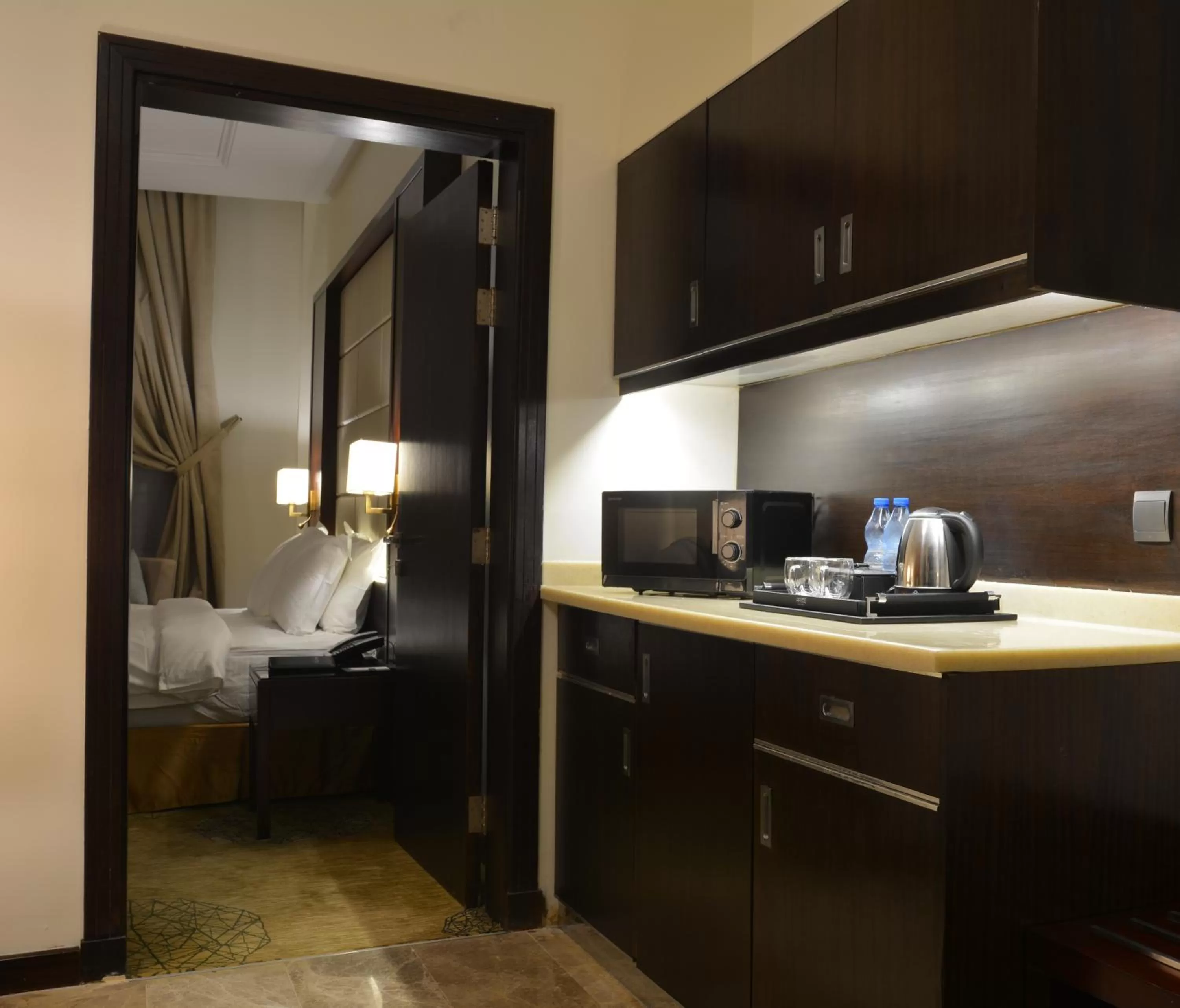 Kitchen or kitchenette, Bed in Prime Al Hamra Hotel