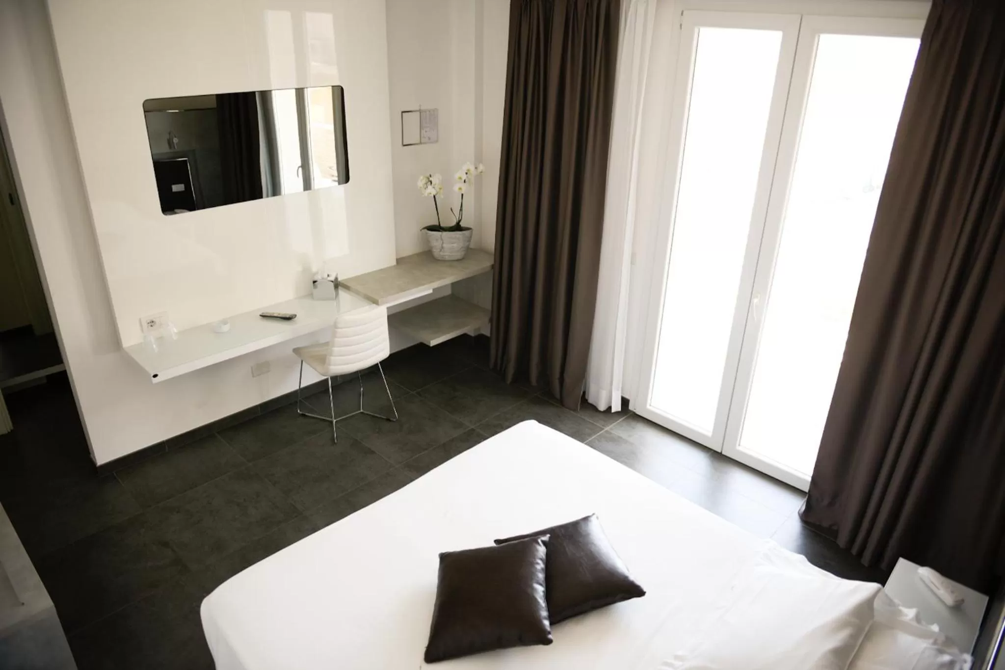 Living room, Bed in Baldinini Hotel