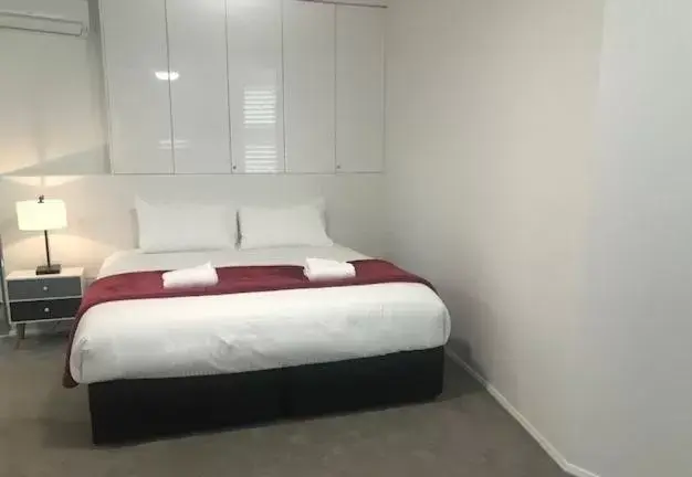 Bed in Sunrise Luxury Apartments
