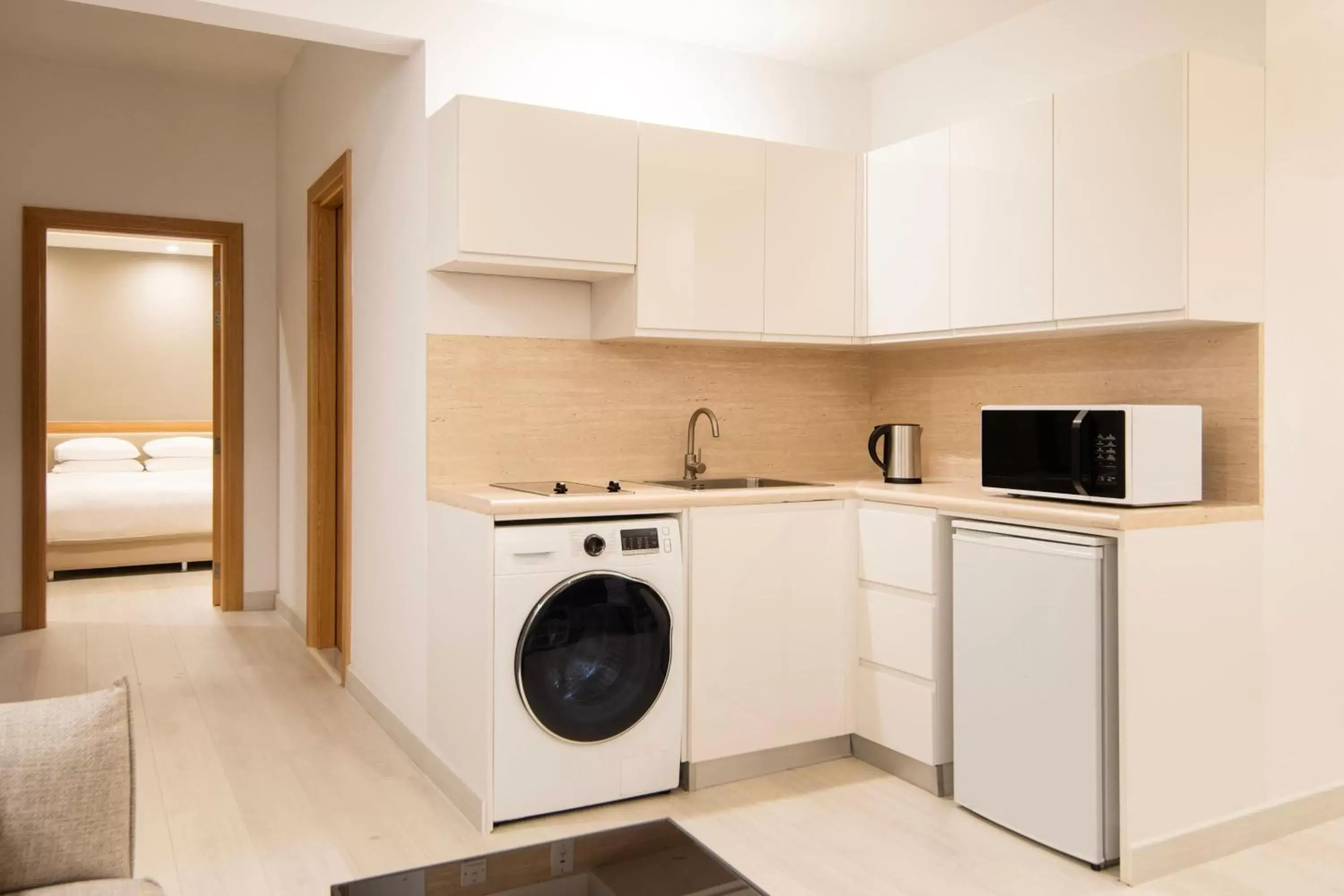 Bedroom, Kitchen/Kitchenette in Marriott Executive Apartments City Center Doha