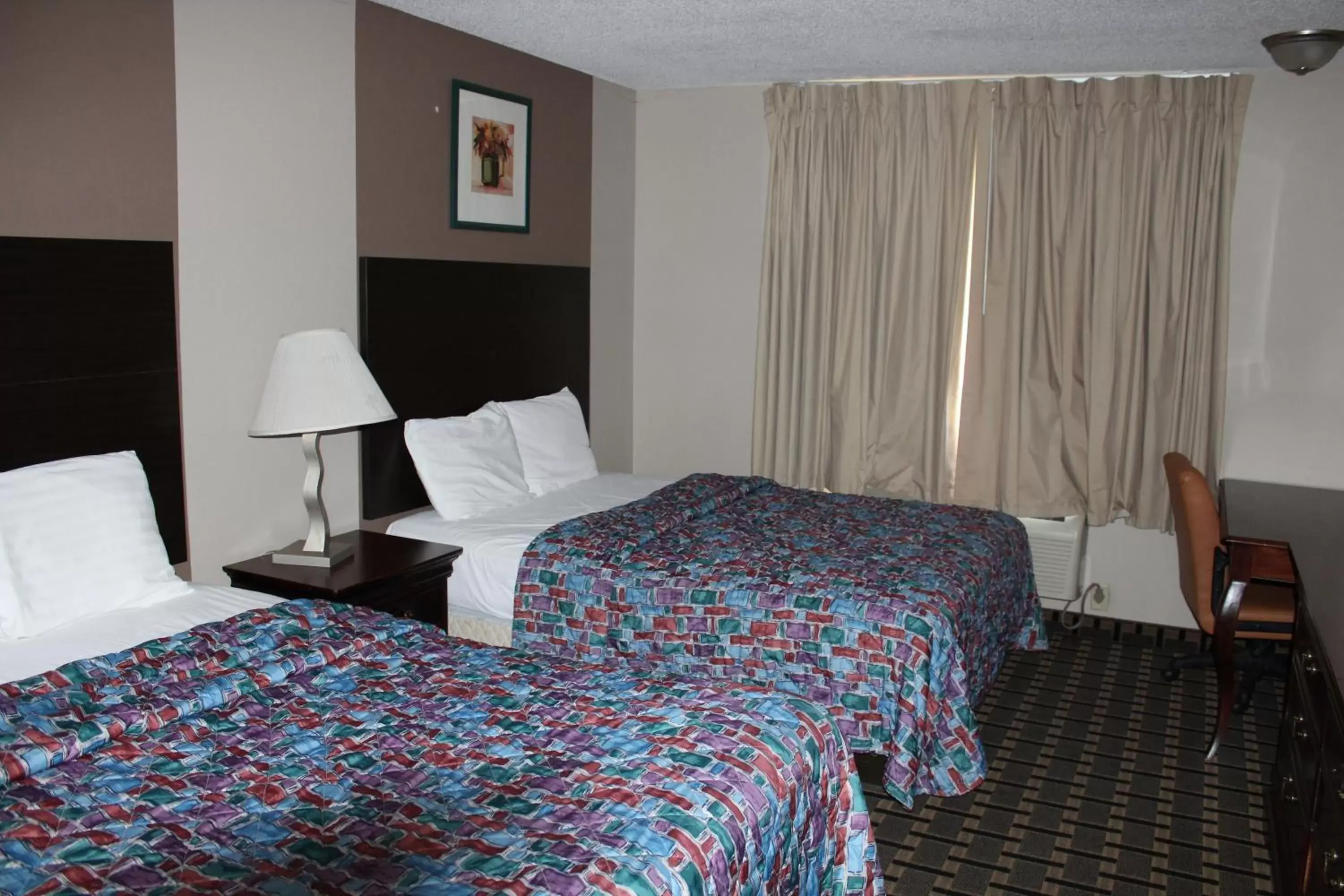 Living room, Bed in Coratel Inn and Suites Maple Grove