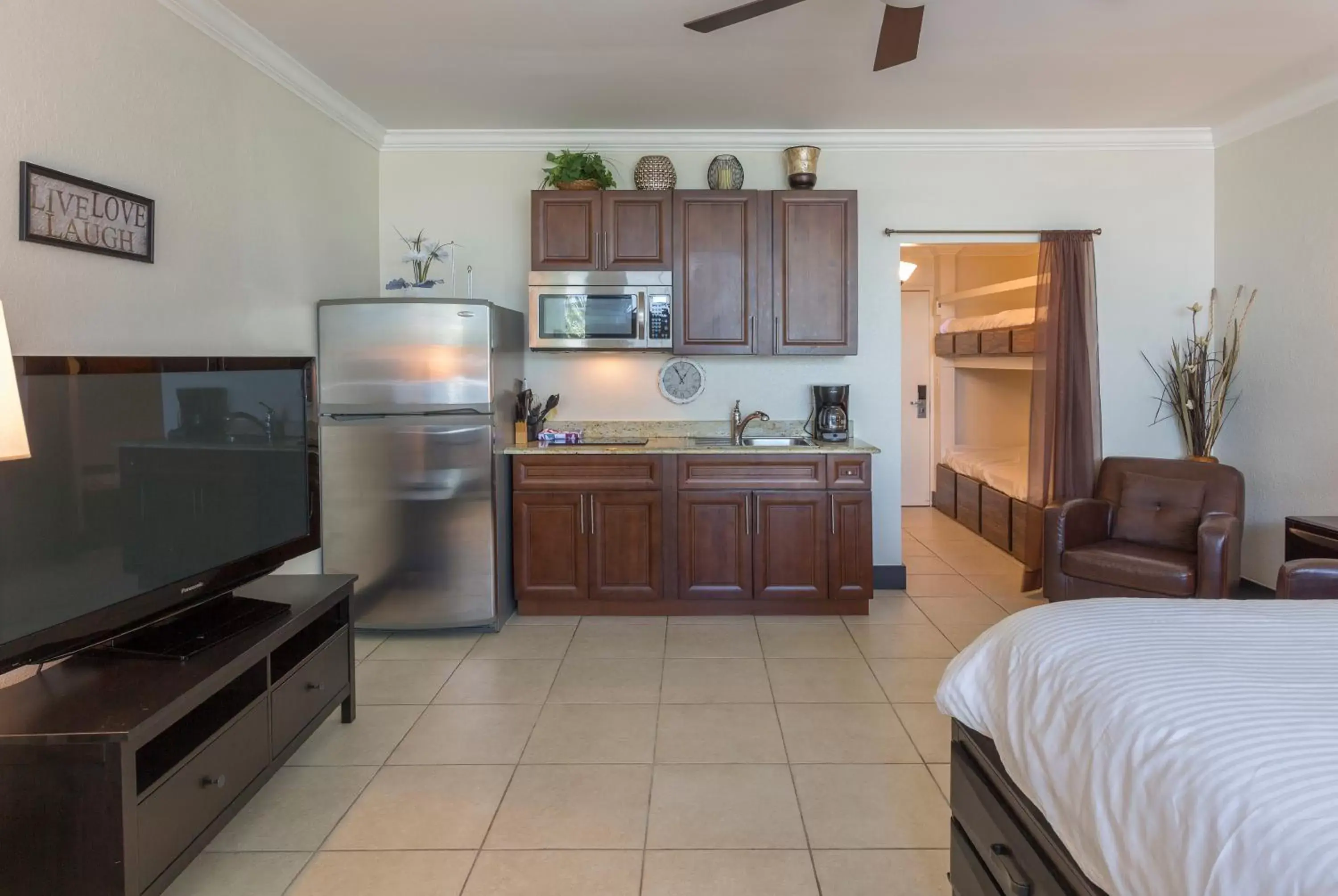 Bed, Kitchen/Kitchenette in DOLPHINS, BEACH step away, WIFI, FREE PARKING,POOLS, JACUZZI