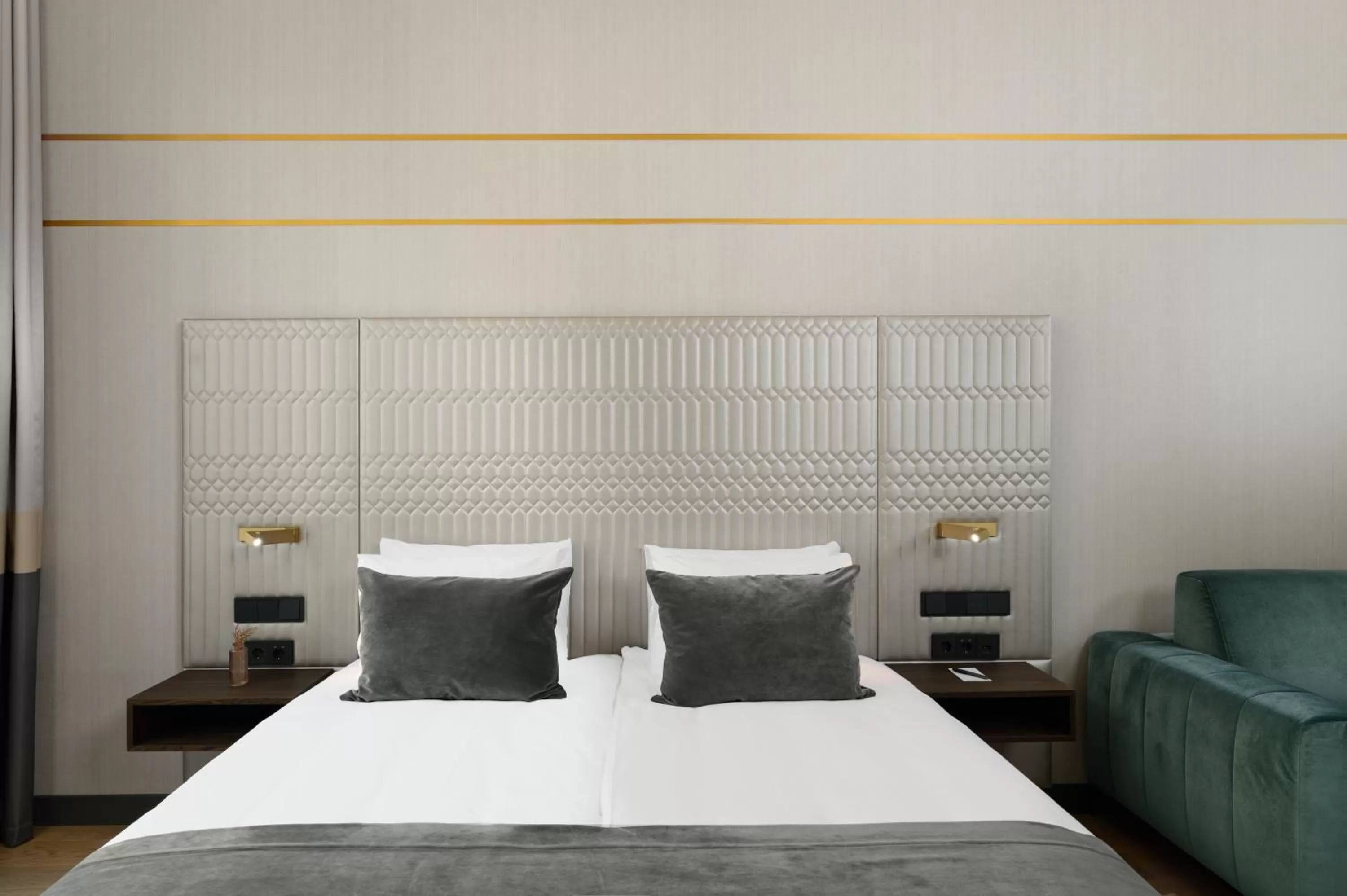 Bed in Emerald Downtown Luxury Suites by Continental Group