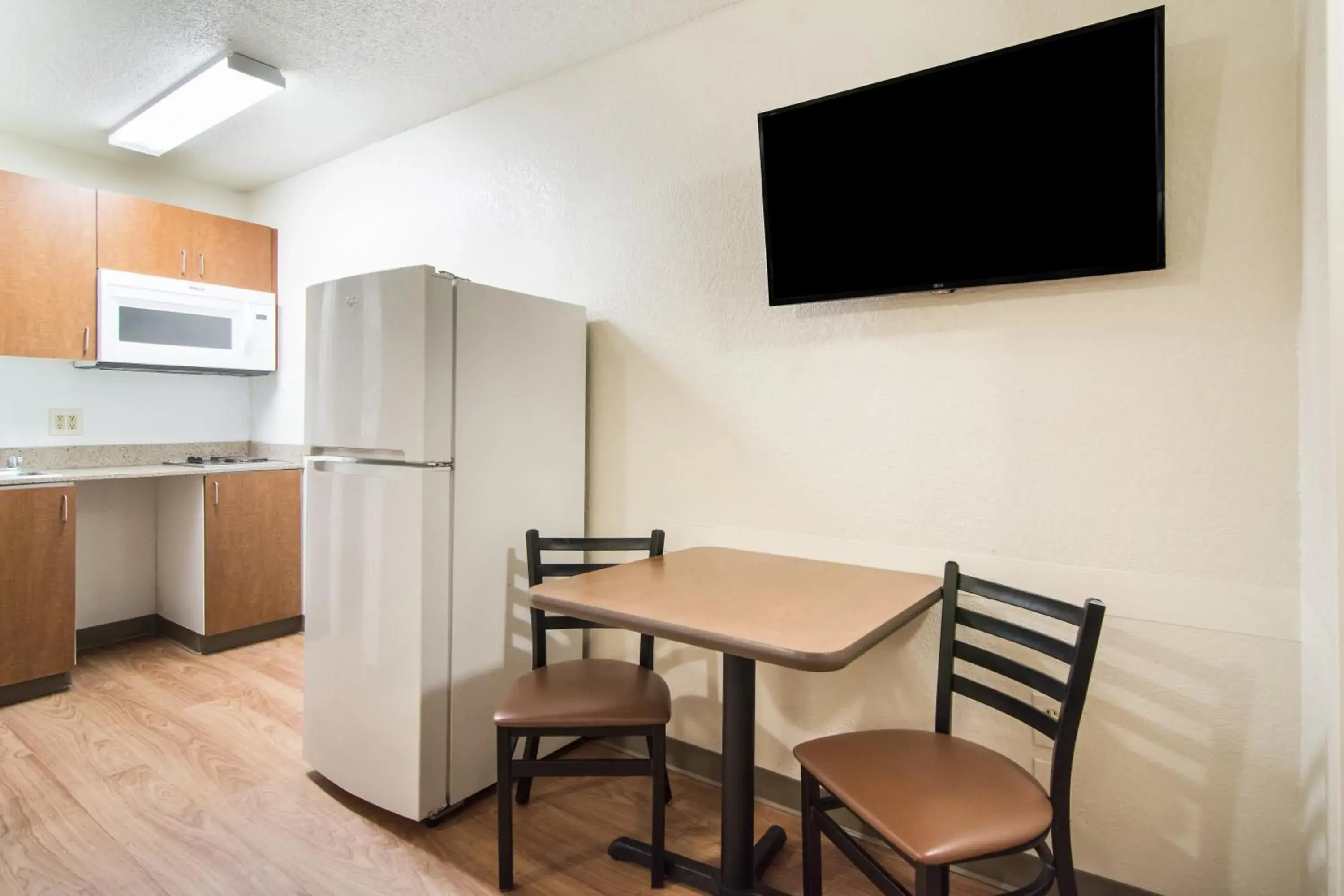 Photo of the whole room, TV/Entertainment Center in HomeTowne Studios by Red Roof Raleigh – Durham